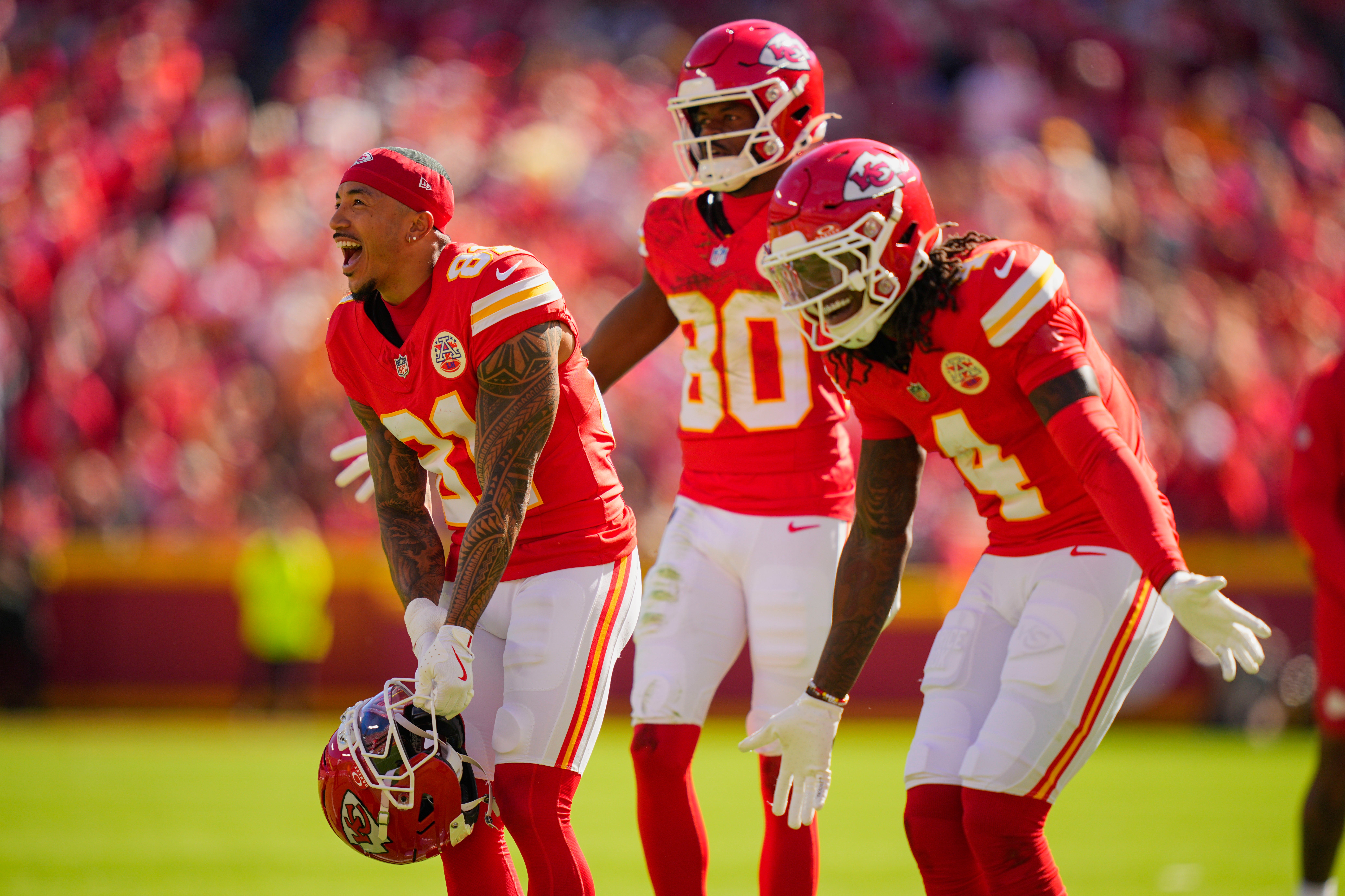 Kansas City Chiefs wide receivers Nikko Remigio (81), Tyquan Thornton (80), and Rashee Rice (4) celebrate after a touchdown during the first half against the Las Vegas Raiders