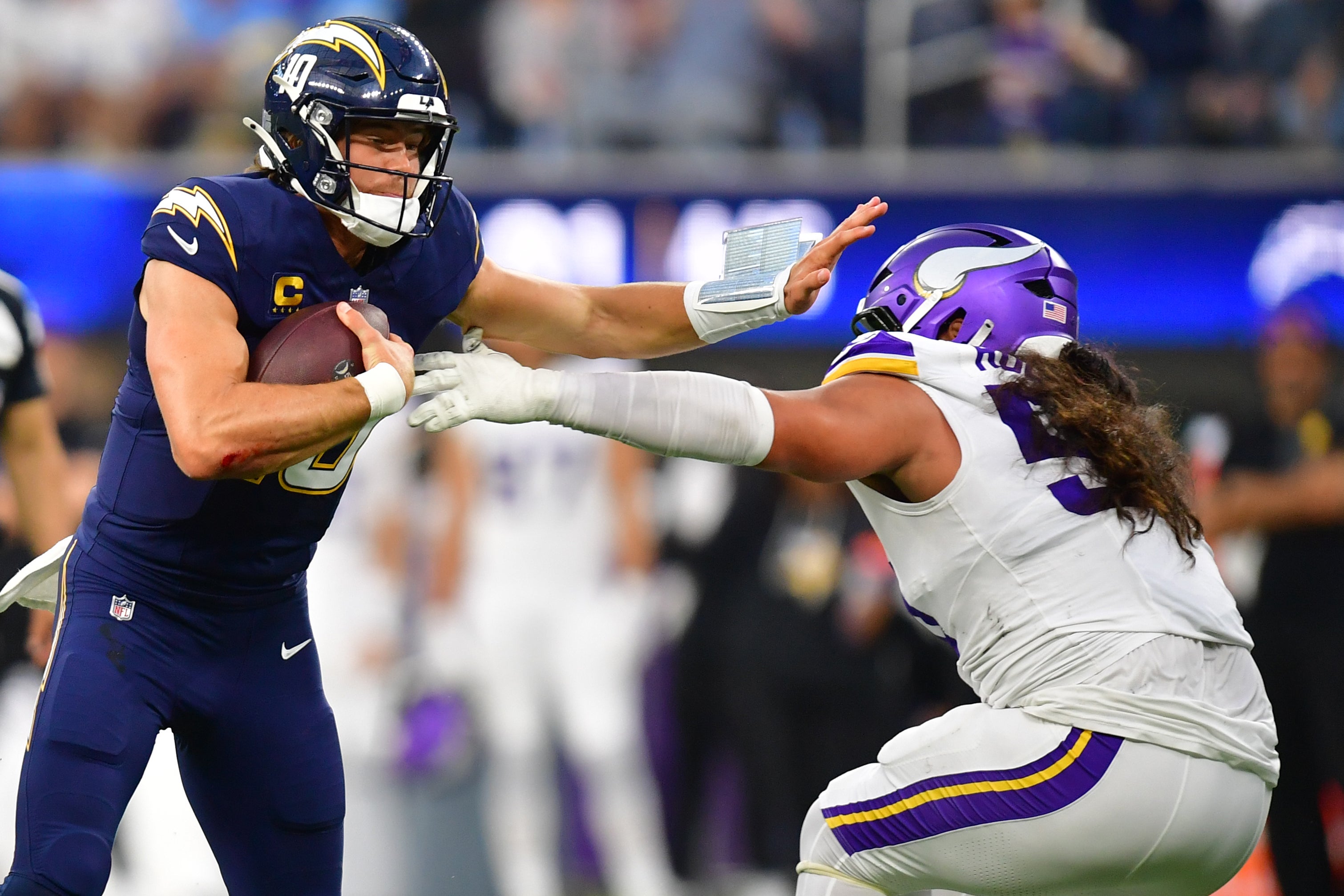 Oct 23, 2025; Inglewood, California, USA; Los Angeles Chargers quarterback Justin Herbert (10) ruses the ball against the Minnesota Vikings during the first half at SoFi Stadium.
