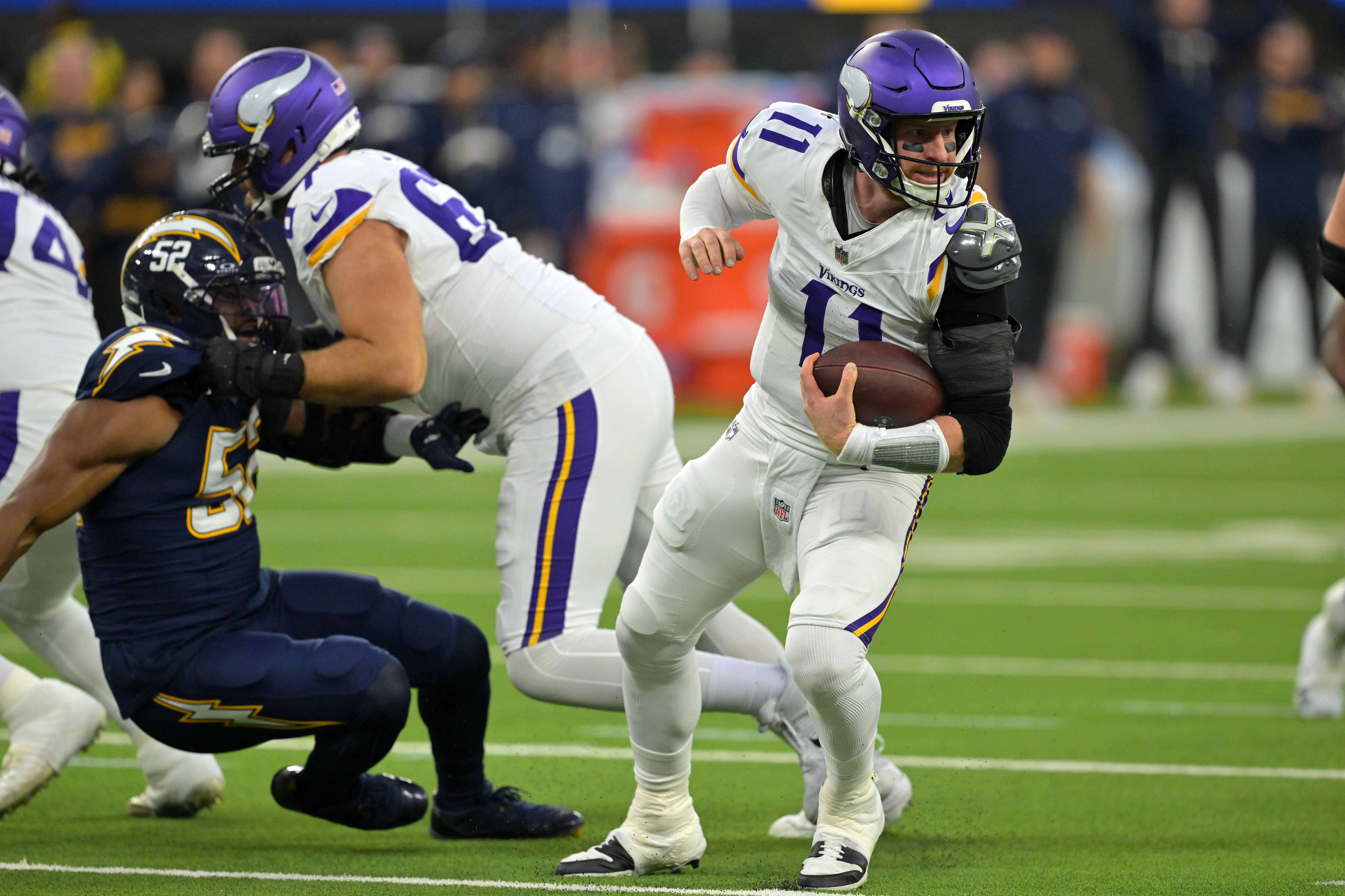 Oct 23, 2025; Inglewood, California, USA; Minnesota Vikings quarterback Carson Wentz (11) rushes the ball against the Los Angeles Chargers during the first half at SoFi Stadium.