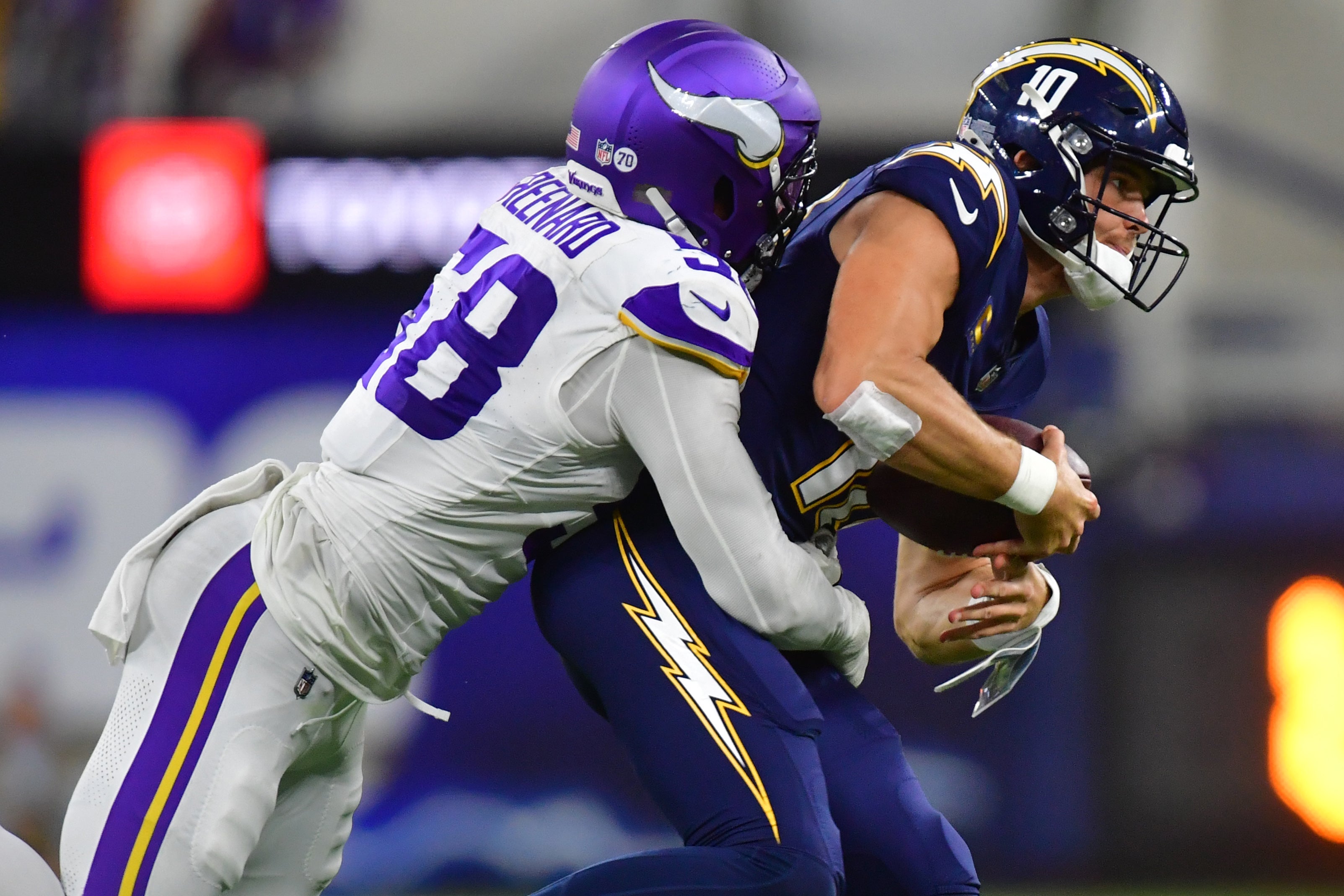 Oct 23, 2025; Inglewood, California, USA; Minnesota Vikings linebacker Jonathan Greenard (58) gets pressure on Los Angeles Chargers quarterback Justin Herbert (10) during the first half at SoFi Stadium.