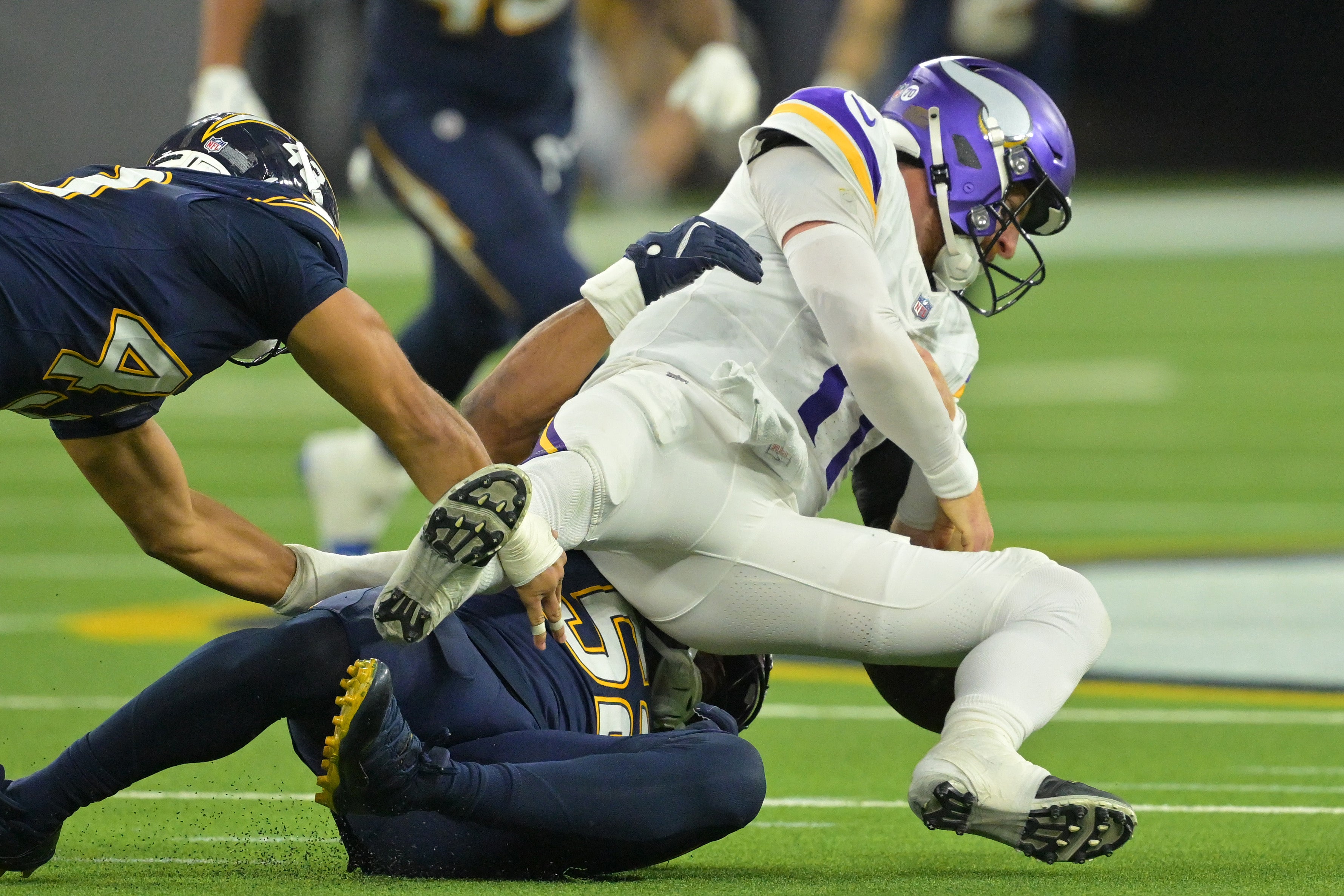 Oct 23, 2025; Inglewood, California, USA; Los Angeles Chargers linebacker Khalil Mack (52) sacks Minnesota Vikings quarterback Carson Wentz (11) during the second half at SoFi Stadium.