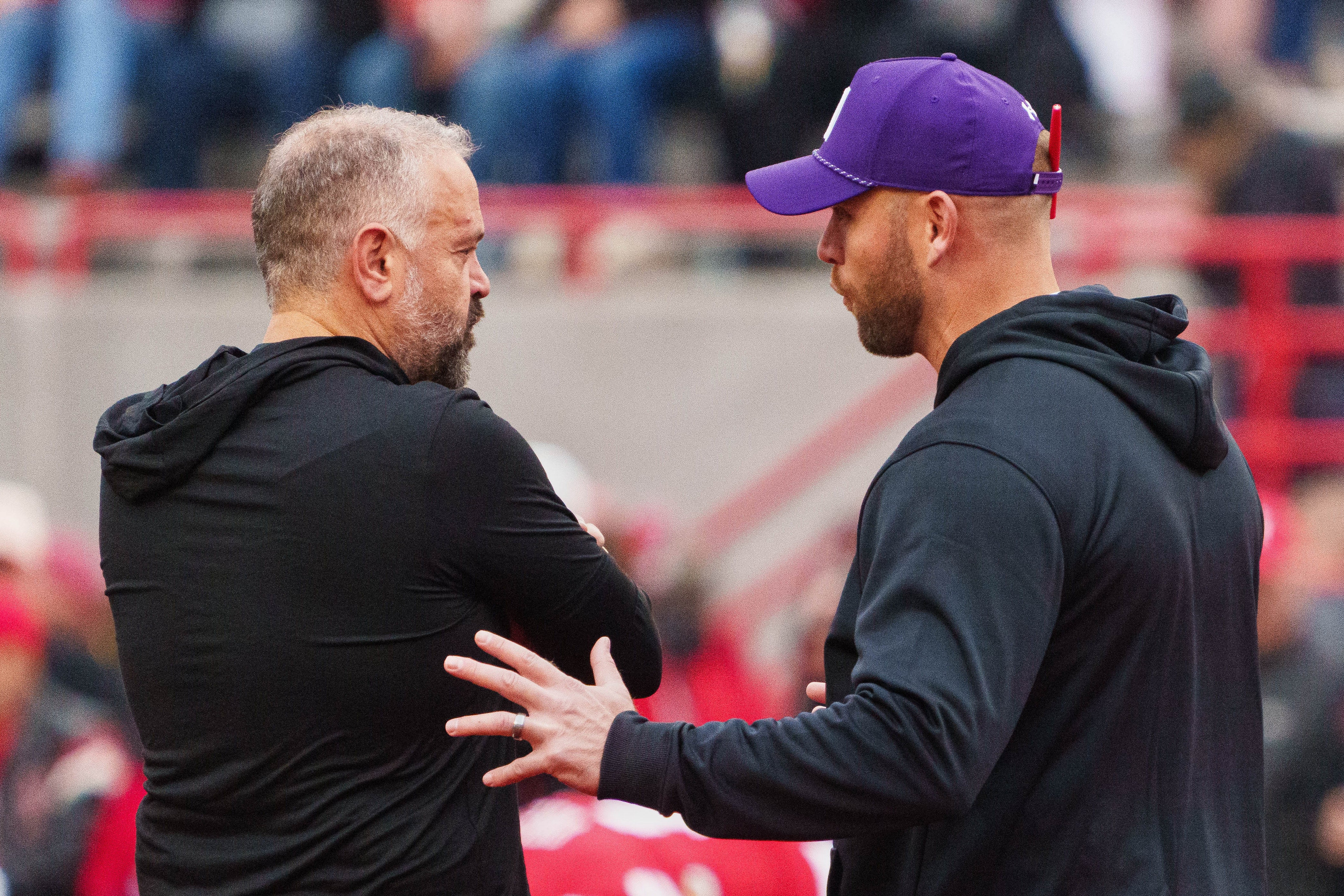 Oct 25, 2025; Lincoln, Nebraska, USA; Nebraska Cornhuskers head coach Matt Rhule (left) and Northwestern Wildcats head coach David Braun talk before the game at Memorial Stadium. Mandatory Credit: Dylan Widger-Imagn Images