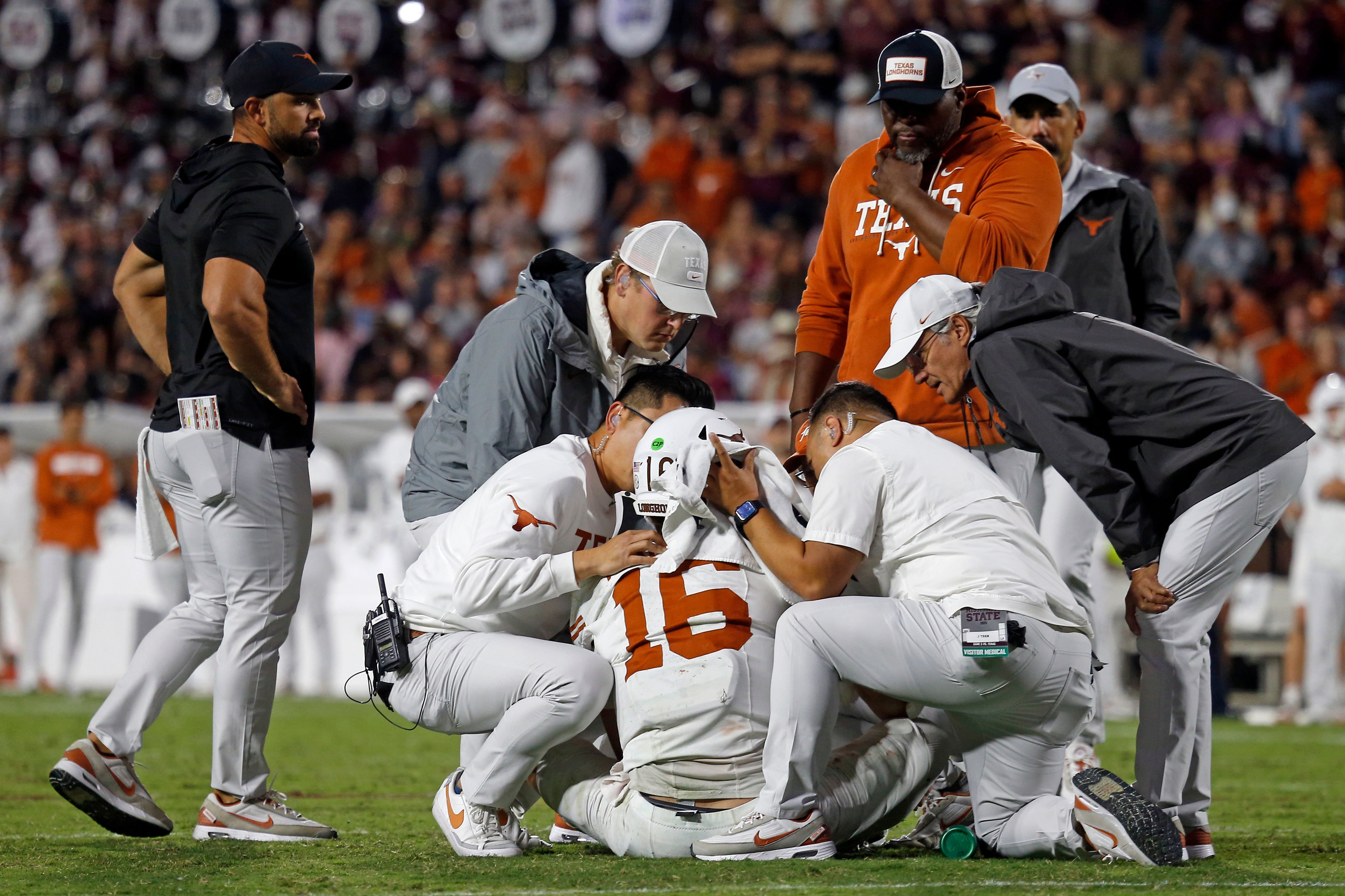 Oct 25, 2025; Starkville, Mississippi, USA; Medical staff check on Texas Longhorns quarterback Arch Manning (16) during overtime against the Mississippi State Bulldogs at Davis Wade Stadium at Scott Field. Mandatory Credit: Petre Thomas-Imagn Images