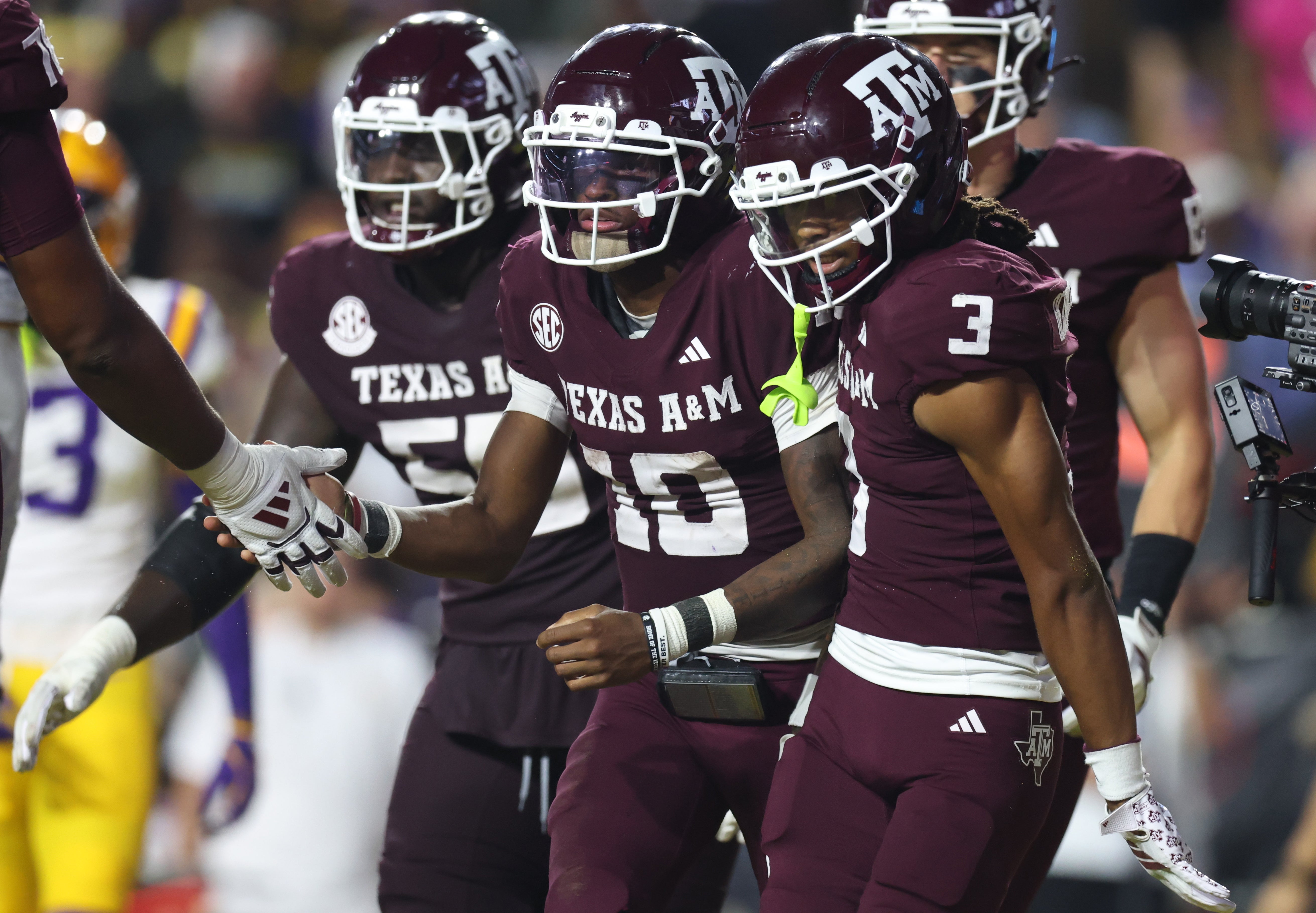 Oct 25, 2025; Baton Rouge, Louisiana, USA; Texas A&M Aggies quarterback Marcel Reed (10) celebrates with wide receiver Ashton Bethel-Roman (3) after a play during the second half against the Louisiana State Tigers at Tiger Stadium.