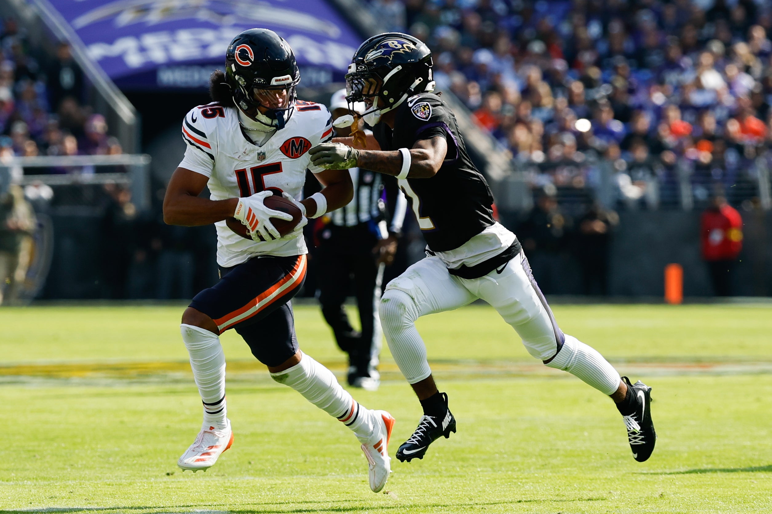 Oct 26, 2025; Baltimore, Maryland, USA; Chicago Bears wide receiver Rome Odunze (15) runs after making a catch as Baltimore Ravens cornerback Nate Wiggins (2) defends during the first quarter at M&T Bank Stadium.