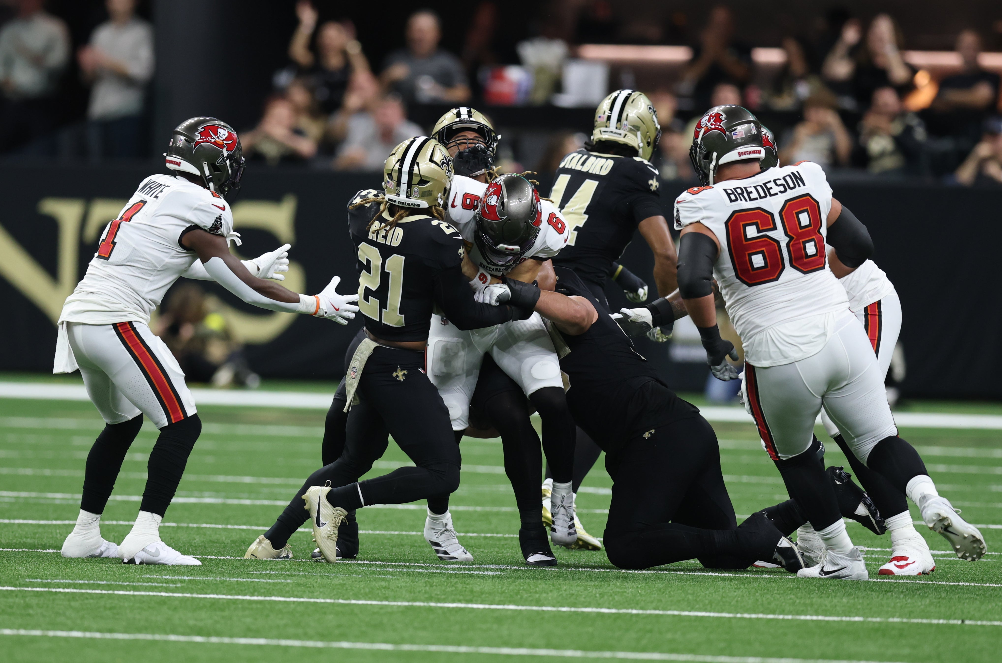 Oct 26, 2025; New Orleans, Louisiana, USA; Tampa Bay Buccaneers quarterback Baker Mayfield (6) is tackled by New Orleans Saints safety Justin Reid (21) during the first quarter at Caesars Superdome.