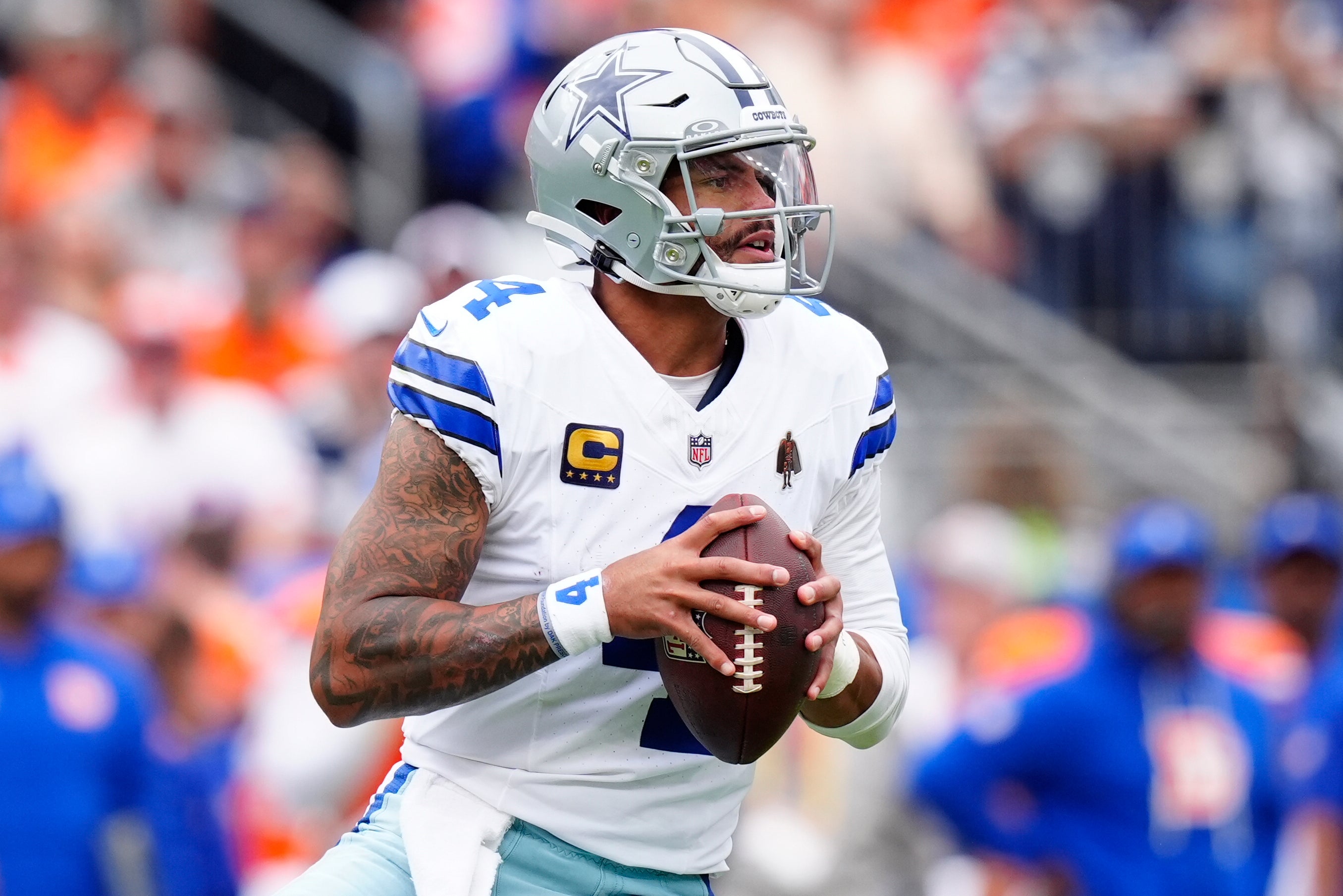 Dallas Cowboys quarterback Dak Prescott (4) looks to throw against the Denver Broncos in the first half at Empower Field at Mile High.