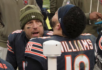 Case Keenum speaks with Caleb Williams on the sideline in Week 10.