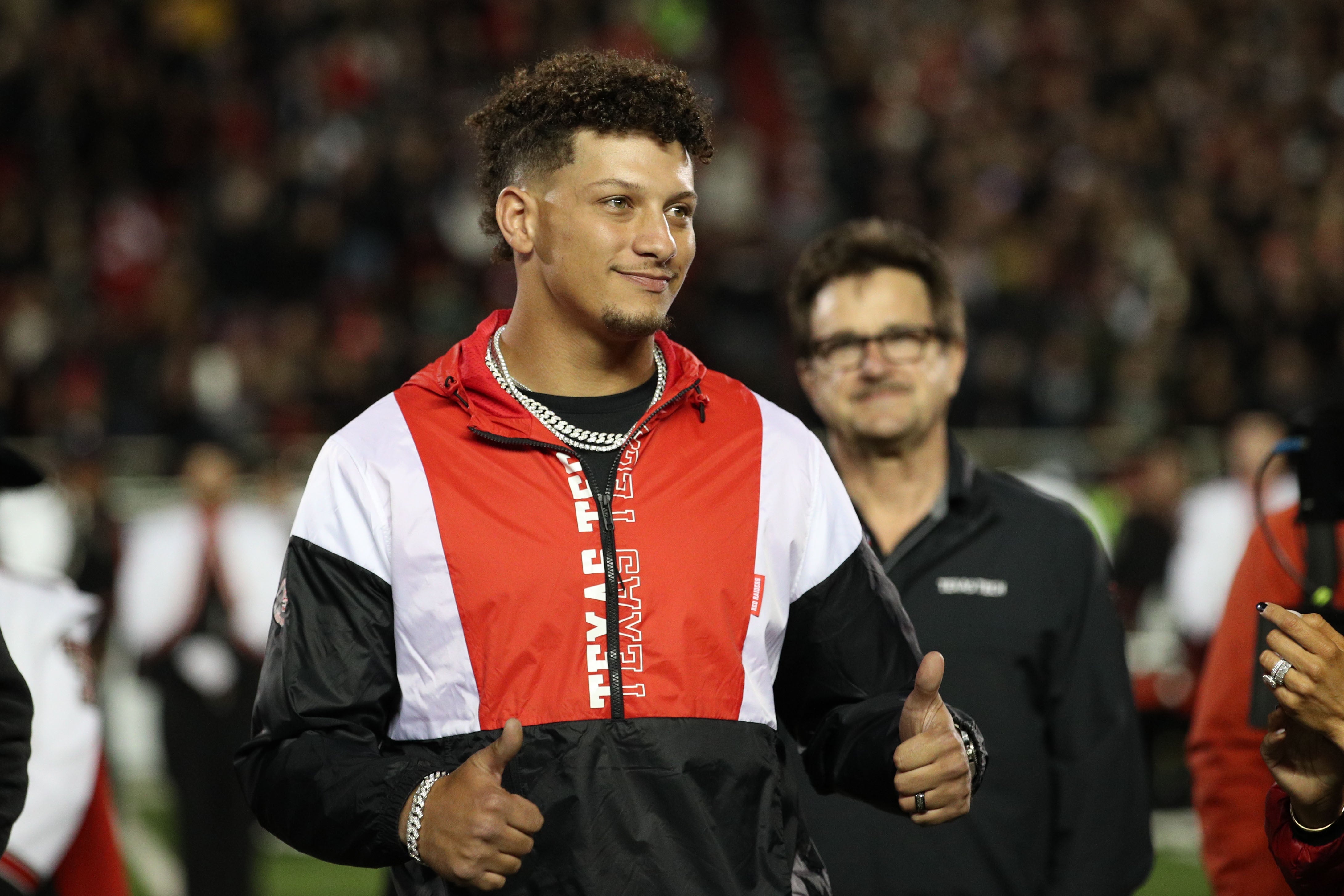 Kansas City Chiefs quarterback Patrick Mahomes gives two thumbs up during his induction into the Ring of Honor during halftime of the game between the Texas Tech Red Raiders and the Baylor Bears at Jones AT&T Stadium and Cody Campbell Field.