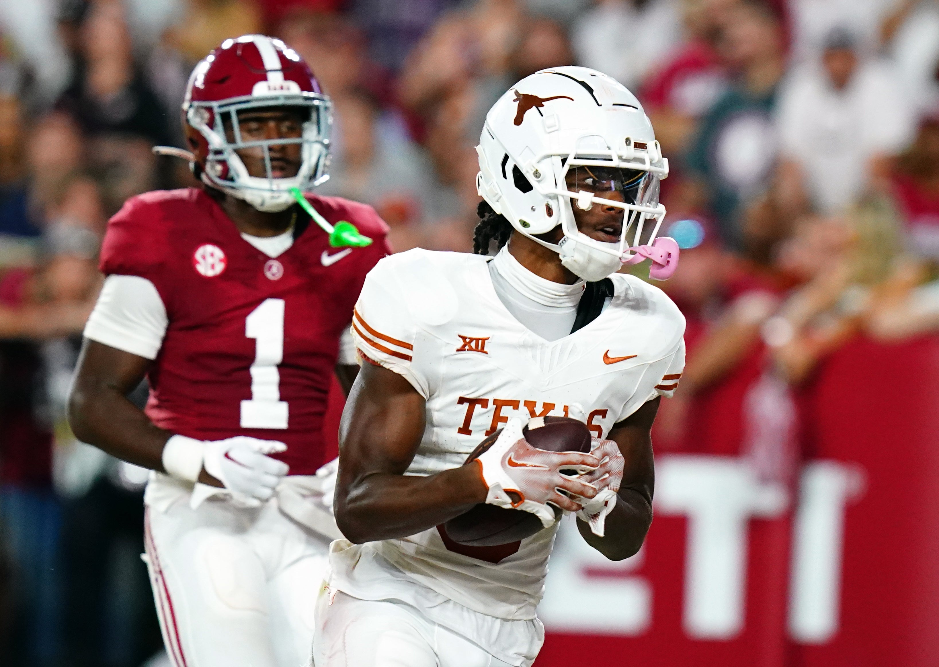Sep 9, 2023; Tuscaloosa, Alabama, USA; Texas Longhorns wide receiver Adonai Mitchell (5) hauls in a touchdown pass over Alabama Crimson Tide defensive back Kool-Aid McKinstry (1) during the fourth quarter at Bryant-Denny Stadium.