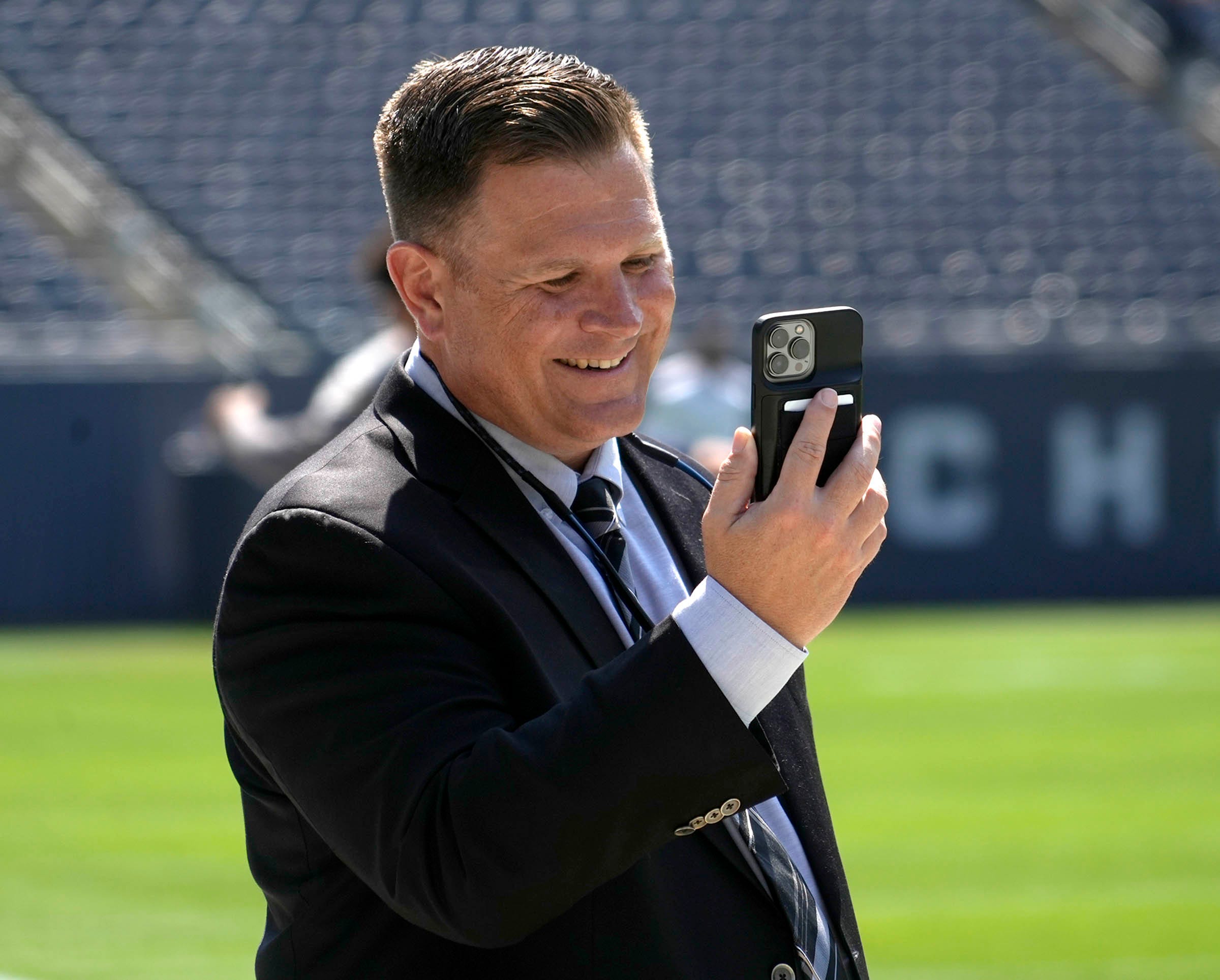 Green Bay Packers general manager Brian Gutekunst face times before the Green Bay Packers play the Chicago Bears on Sunday, Sept. 10, 2023 at Soldier Field in Chicago.