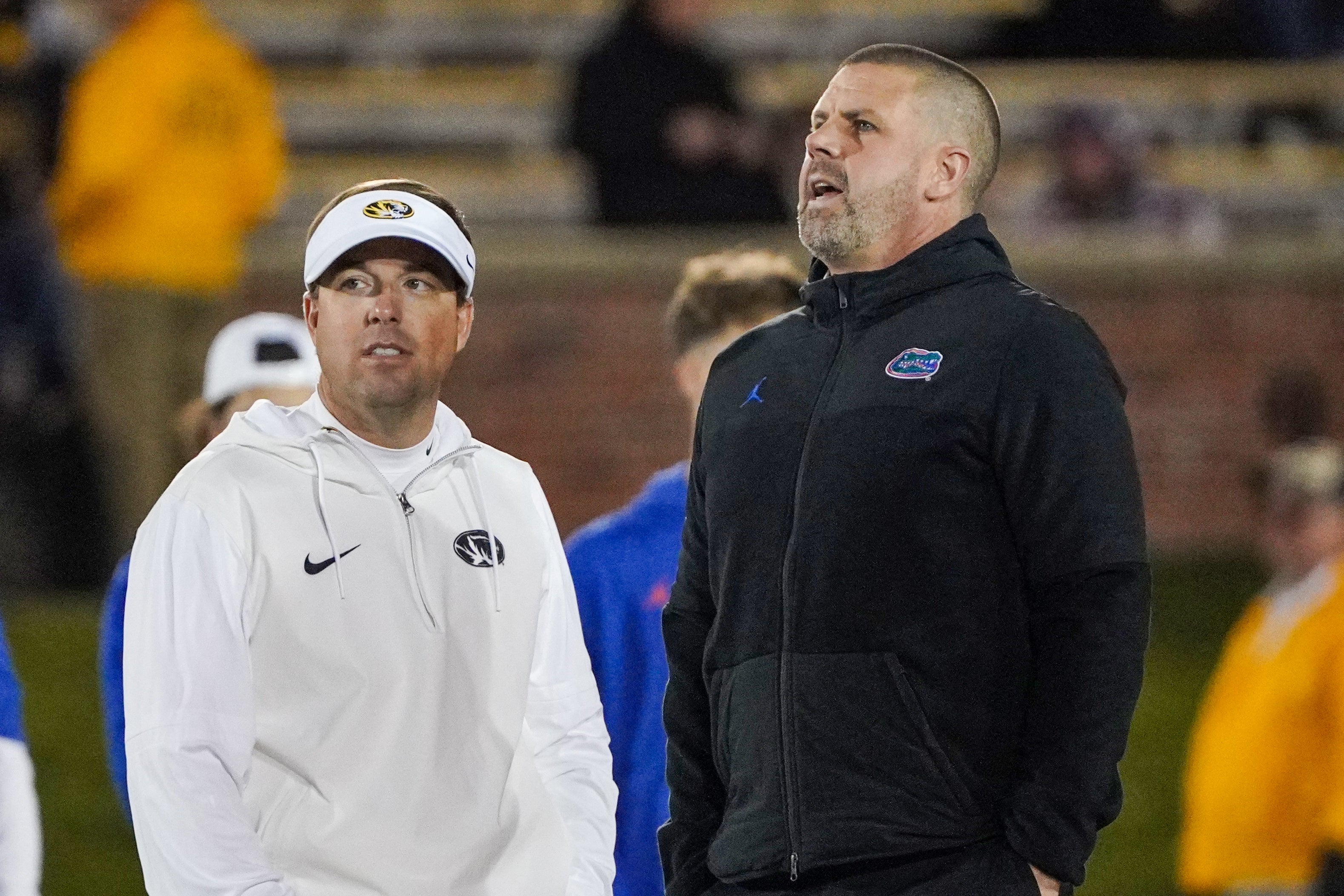 Nov 18, 2023; Columbia, Missouri, USA; Missouri Tigers head coach Eli Drinkwitz, left, talks with Florida Gators head coach Billy Napier prior to a game at Faurot Field at Memorial Stadium.