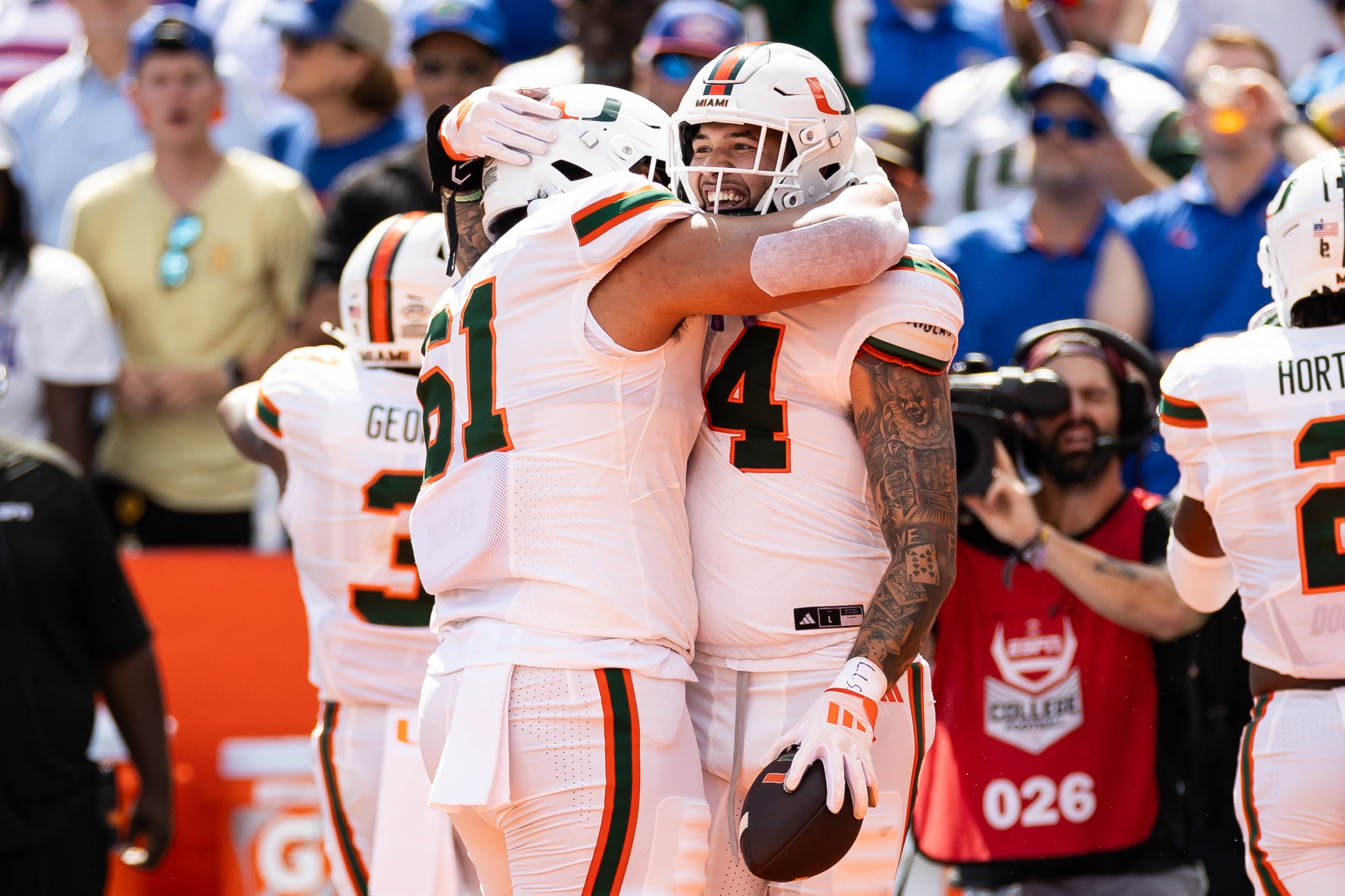 Aug 31, 2024; Gainesville, Florida, USA; Miami Hurricanes tight end Cam McCormick (84) celebrate with offensive lineman Francis Mauigoa (61) after scoring a touchdown against the Florida Gators during the first half at Ben Hill Griffin Stadium. Mandatory Credit: Matt Pendleton-USA TODAY Sports