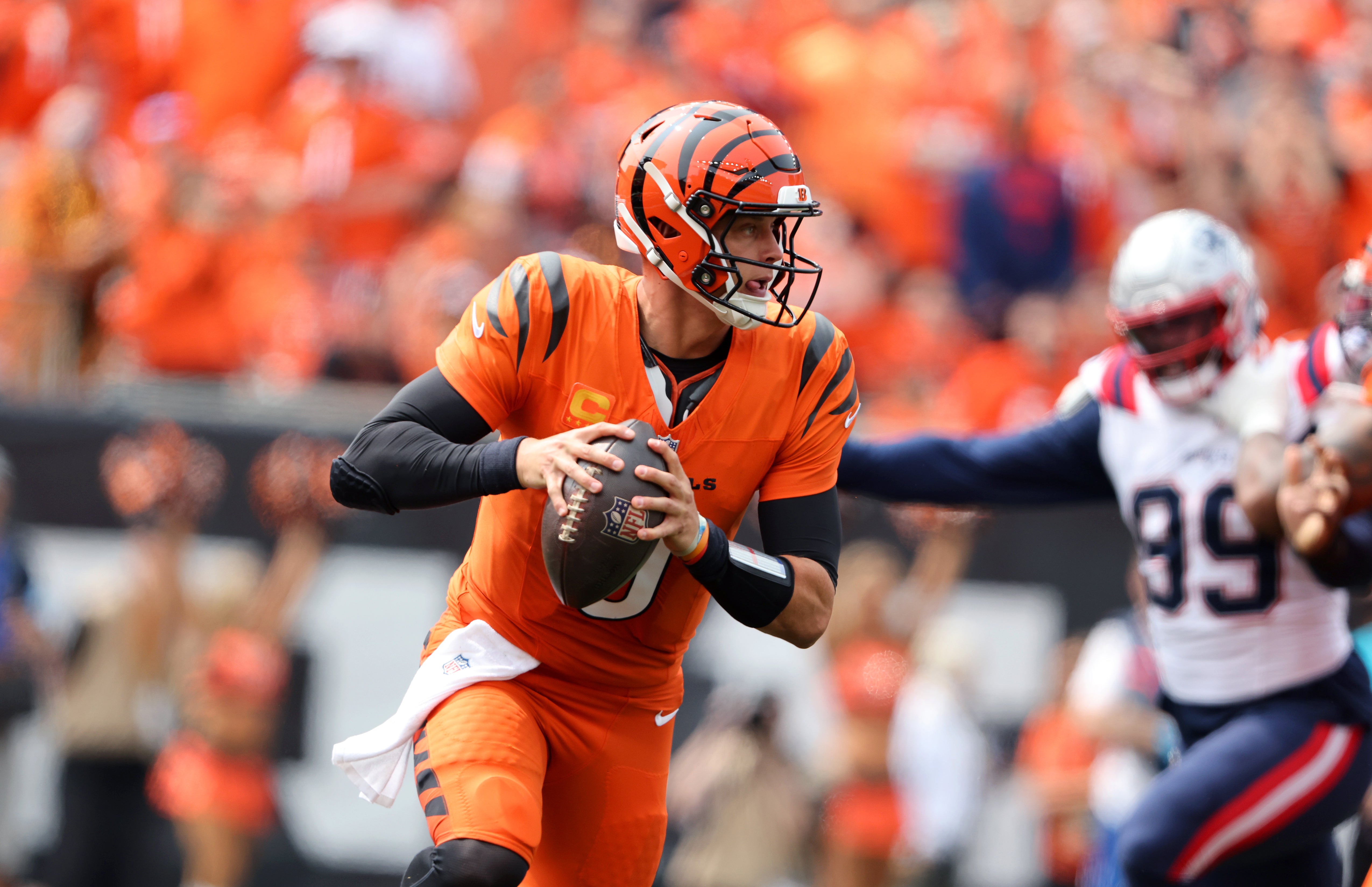 Sep 8, 2024; Cincinnati, Ohio, USA; Cincinnati Bengals quarterback Joe Burrow (9) runs the ball during the first quarter against the New England Patriots at Paycor Stadium.