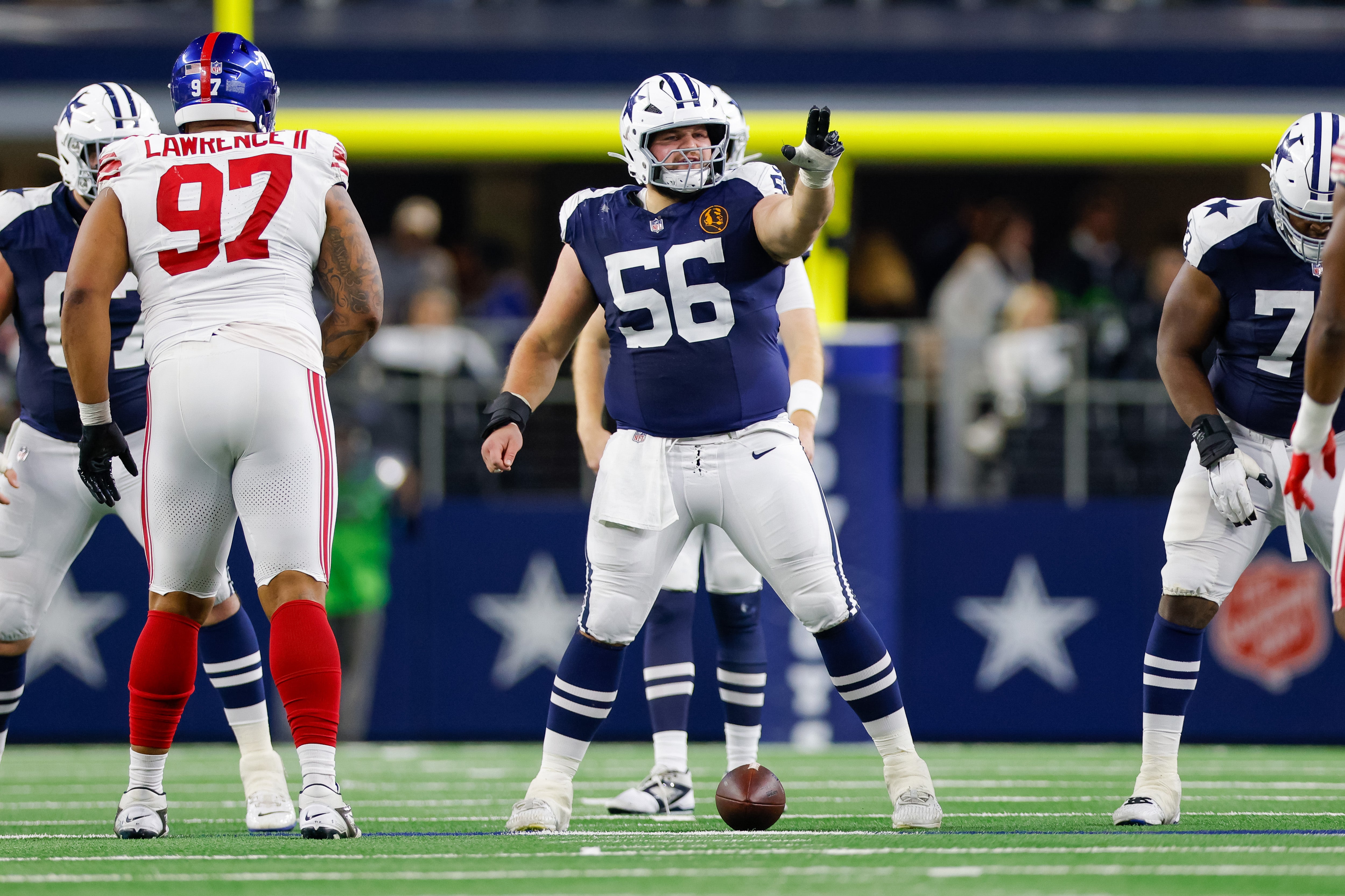 Nov 28, 2024; Arlington, Texas, USA; Dallas Cowboys center Cooper Beebe (56) signals at the line against the New York Giants during the second quarter at AT&T Stadium.