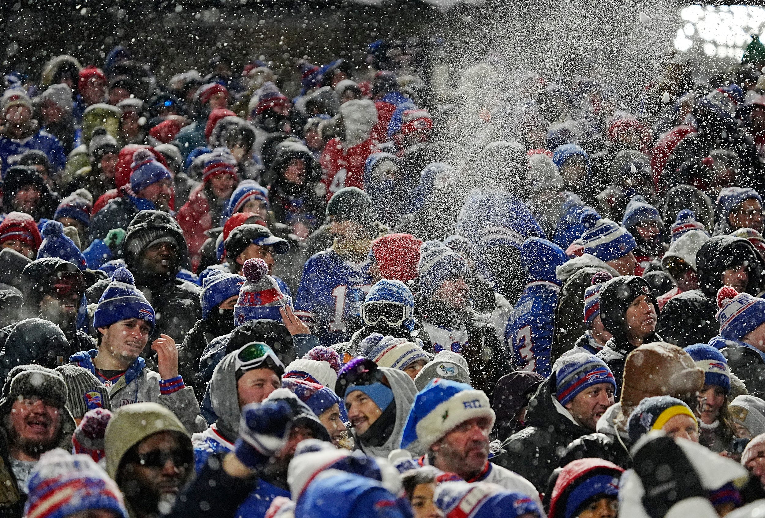 Bills fans throw snow in the air in celebration after James Cook ran 65-yards for a touchdown during first half action of their home game against the San Francisco 49ers in Orchard Park on Dec. 1, 2024.