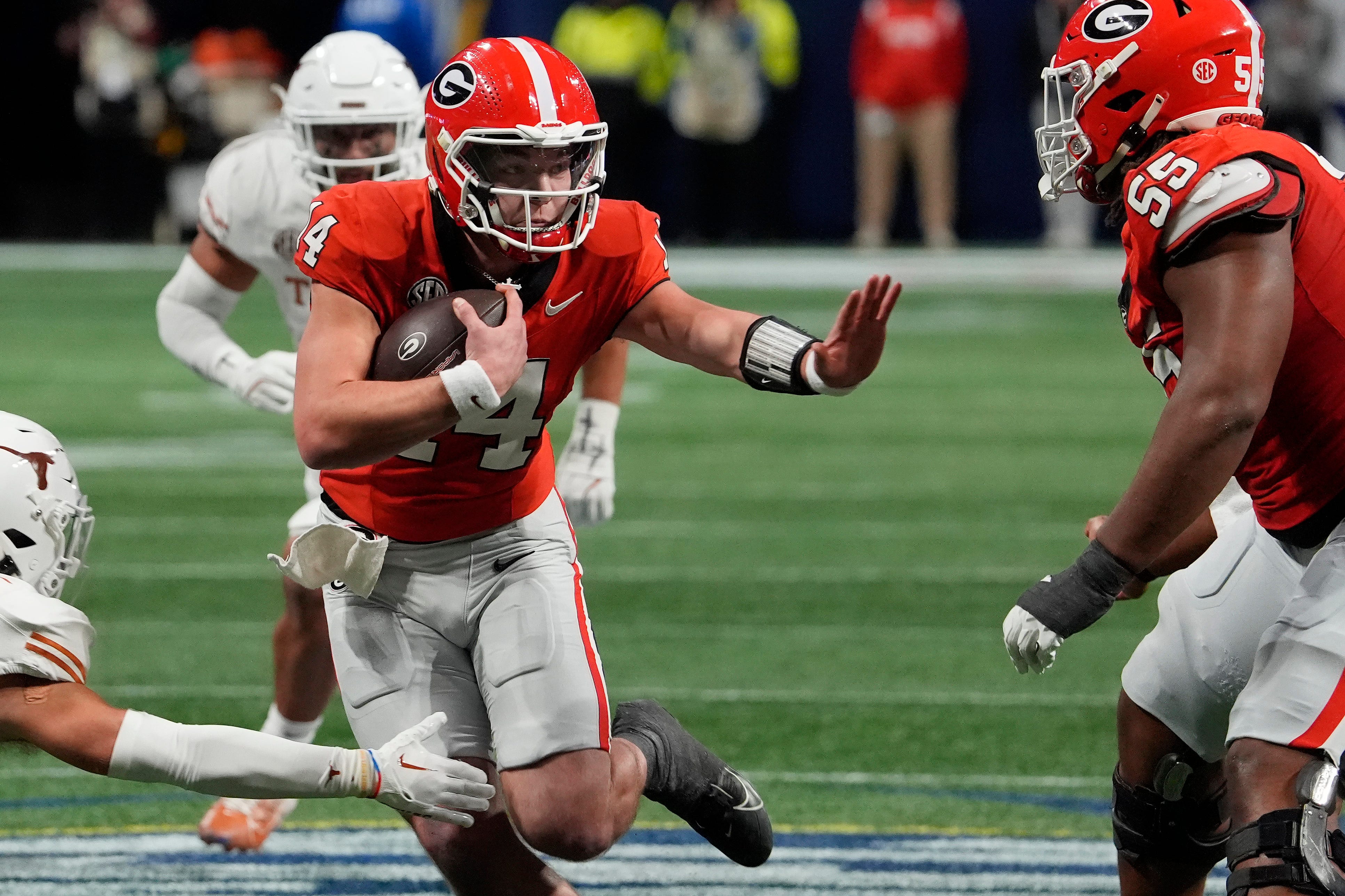 Georgia quarterback Gunner Stockton (14) runs the ball during the second half of the SEC championship game against Texas in Atlanta, on Saturday, Dec. 7, 2024.