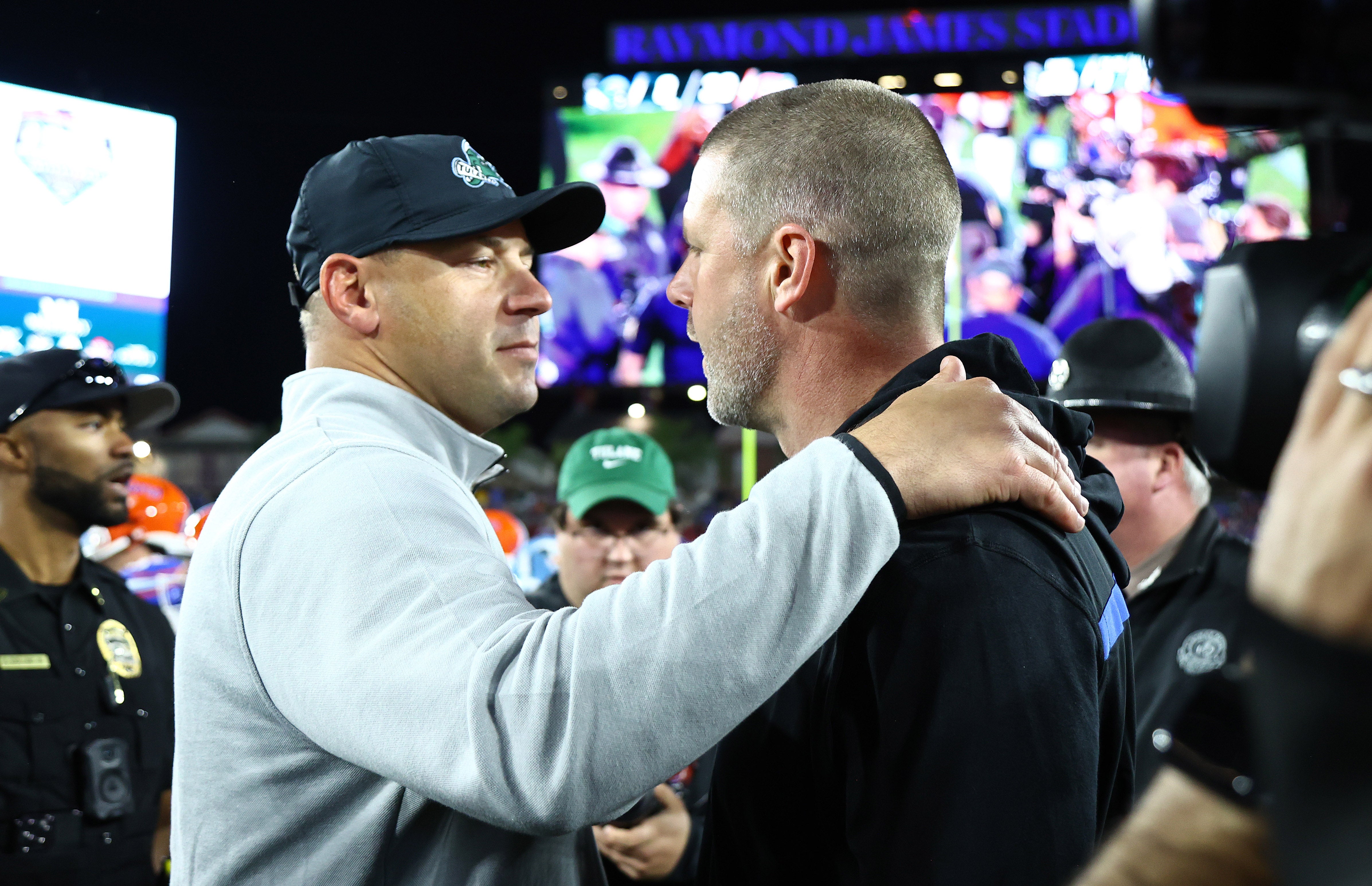 Dec 20, 2024; Tampa, FL, USA; Tulane Green Wave head coach Jon Sumrall and Florida Gators head coach Billy Napier greet after the game at Raymond James Stadium.