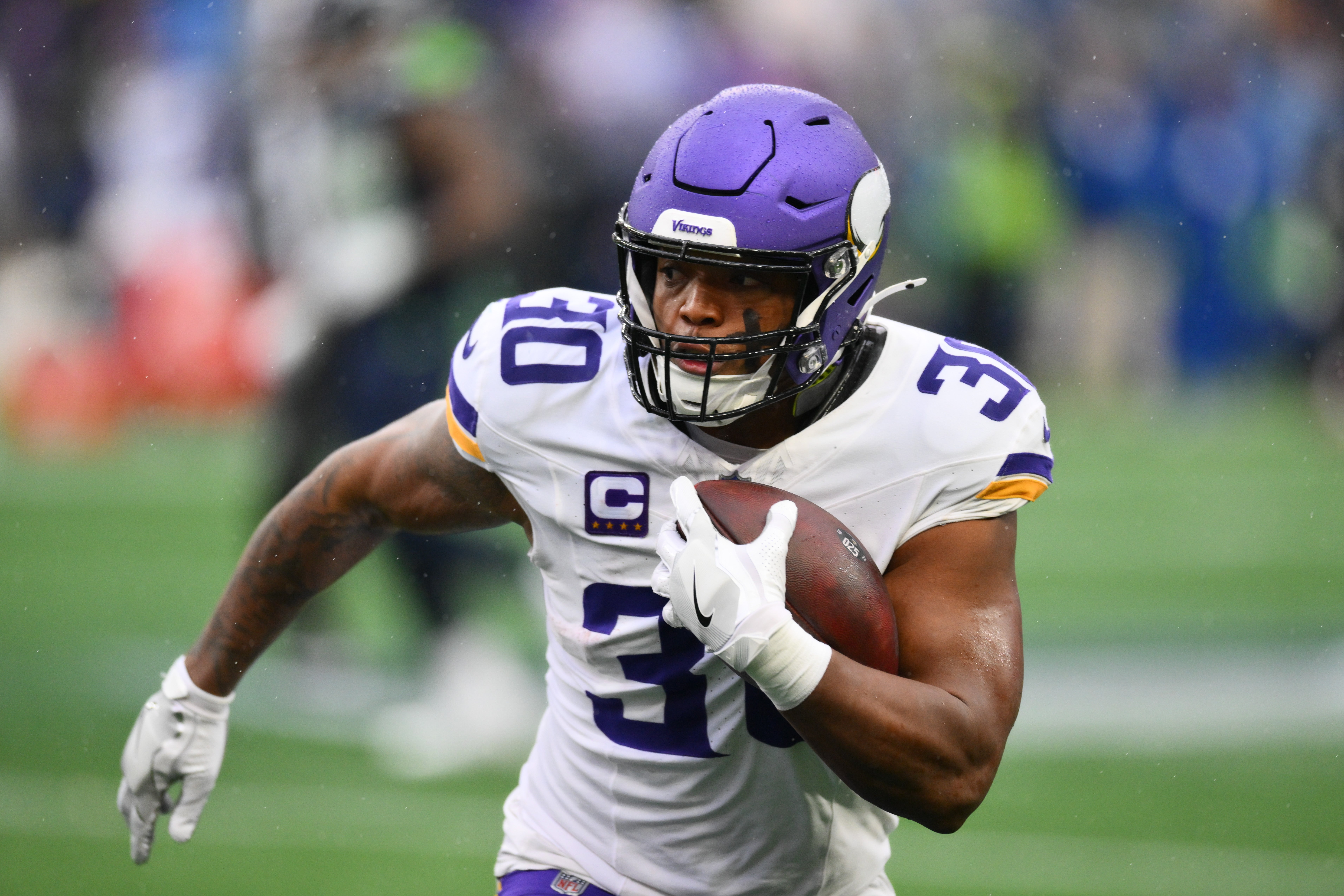 Dec 22, 2024; Seattle, Washington, USA; Minnesota Vikings fullback C.J. Ham (30) carries the ball against the Seattle Seahawks during the first half at Lumen Field.