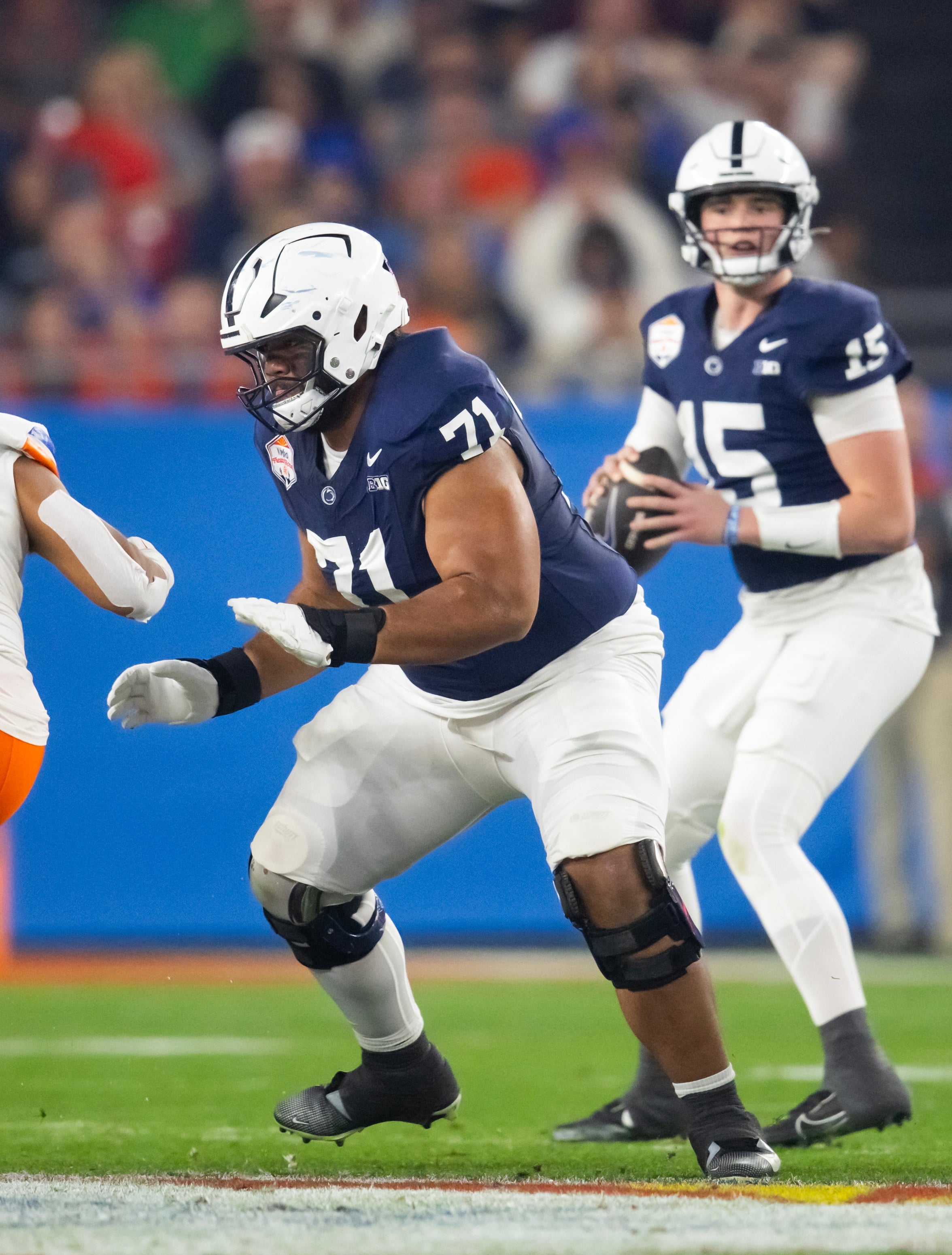 Dec 31, 2024; Glendale, AZ, USA; Penn State Nittany Lions offensive lineman Olaivavega Ioane (71) blocks for quarterback Drew Allar (15) against the Boise State Broncos in the Fiesta Bowl at State Farm Stadium. Mandatory Credit: Mark J. Rebilas-Imagn Images