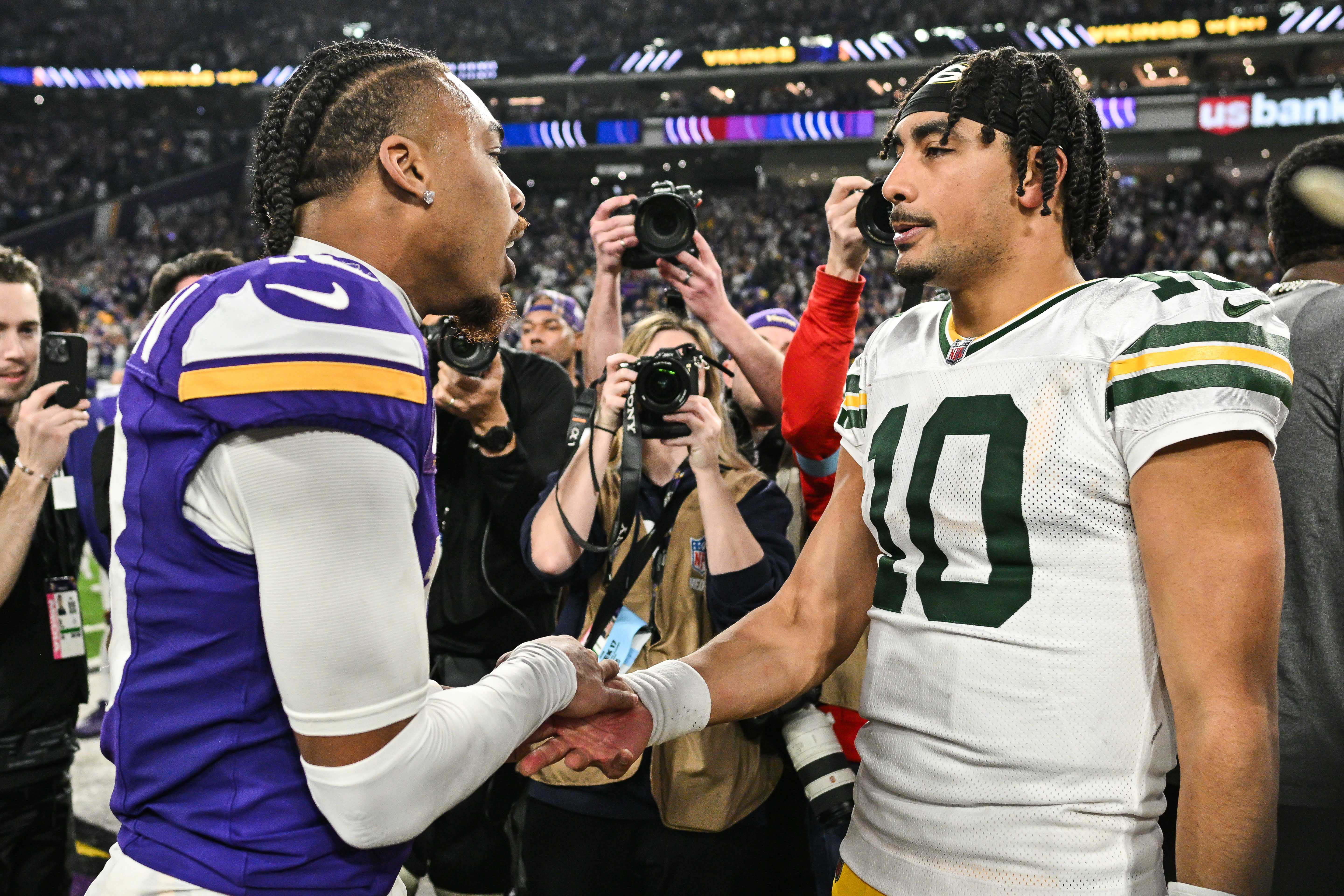 Dec 29, 2024; Minneapolis, Minnesota, USA; Minnesota Vikings wide receiver Justin Jefferson (18) and Green Bay Packers quarterback Jordan Love (10) gather after the game at U.S. Bank Stadium.