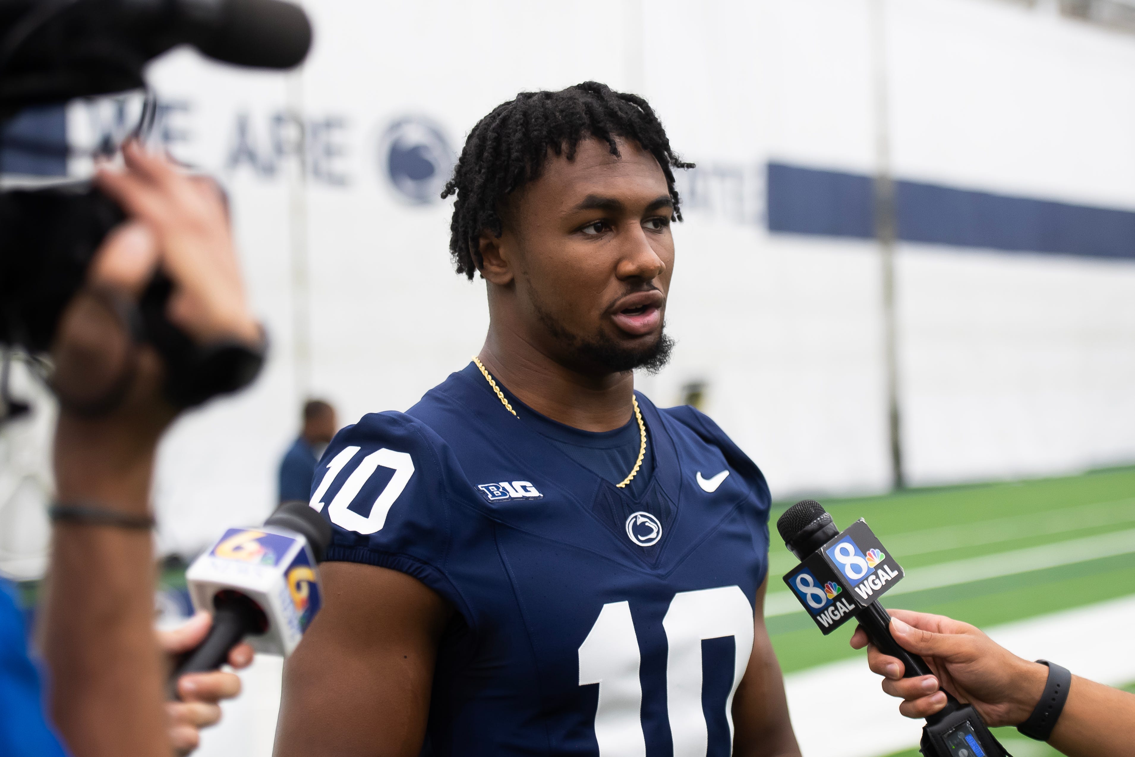 Penn State running back Nick Singleton talks with TV reporters during football media day in Holuba Hall on Saturday, August 2, 2025, in State College.