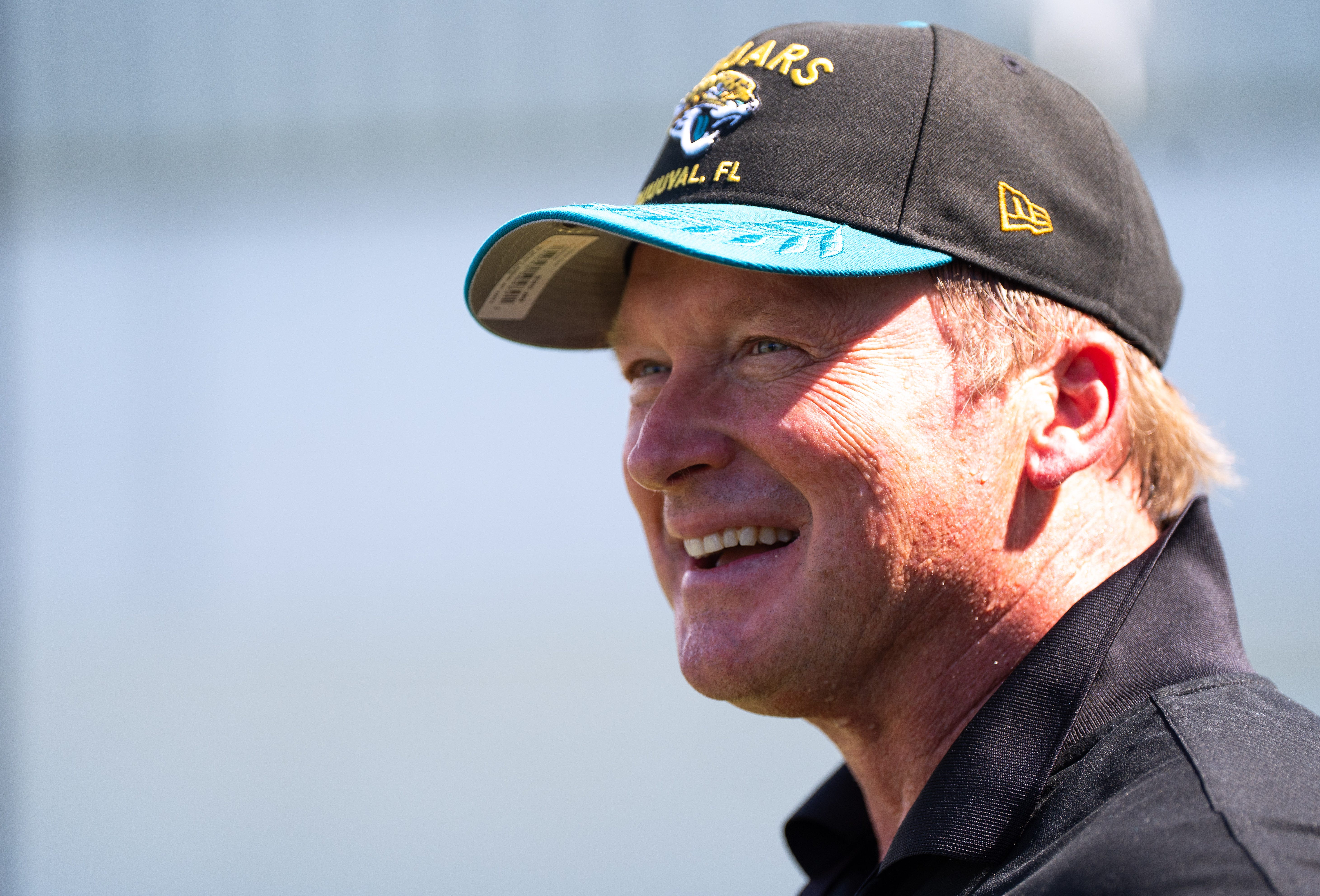 Former NFL Coache Jon Gruden have a laugh while attending an NFL training camp session ten at the Miller Electric Center, Tuesday, Aug. 5, 2025, in Jacksonville, Fla.