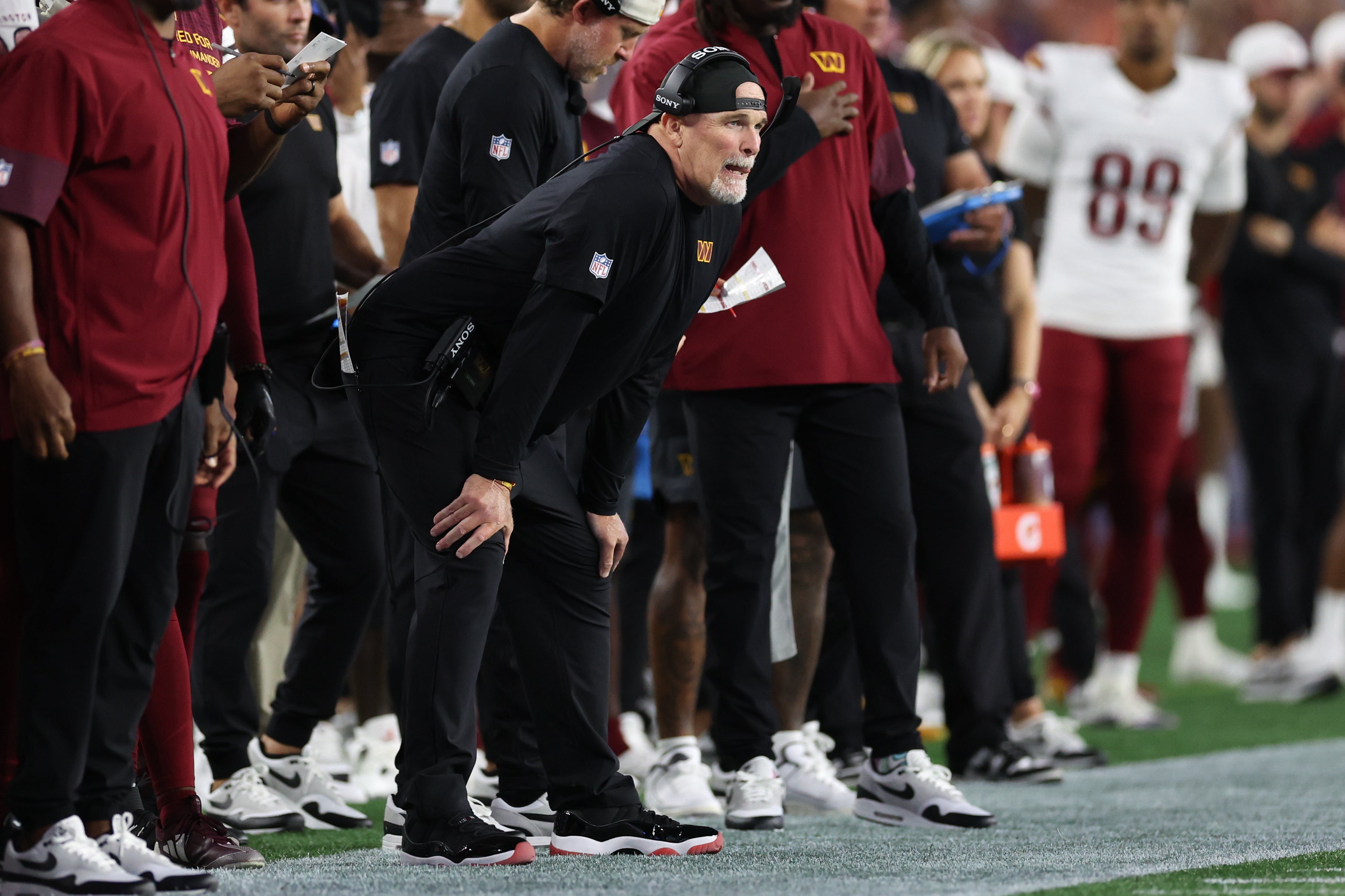 Aug 8, 2025; Foxborough, Massachusetts, USA; Washington Commanders head coach Dan Quinn reacts during the first half against the New England Patriots at Gillette Stadium.