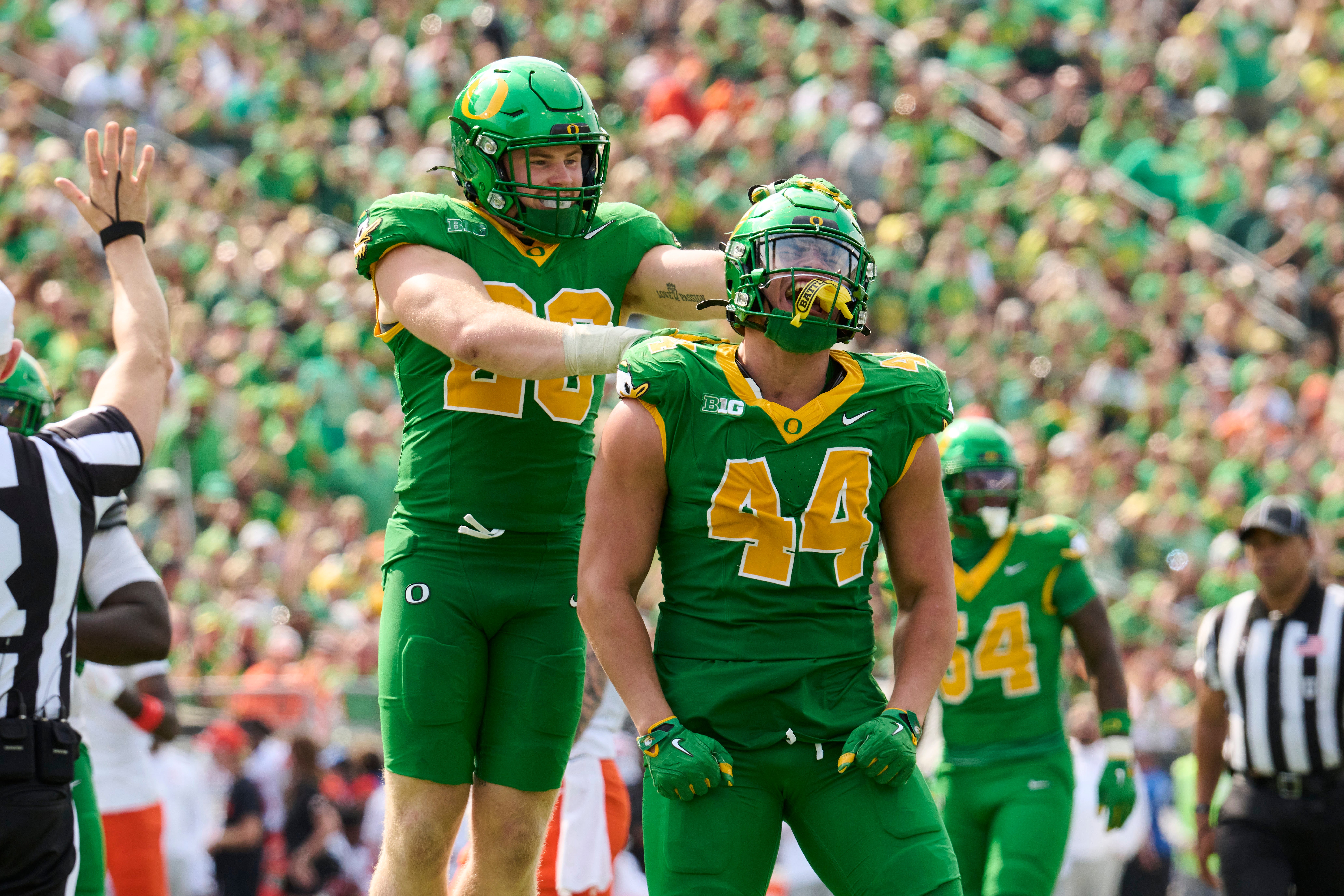 Sep 6, 2025; Eugene, Oregon, USA; Oregon Ducks linebacker Teitum Tuioti (44) celebrates with linebacker Bryce Boettcher (28) after sacking Oklahoma State Cowboys quarterback Zane Flores (6) during the second half at Autzen Stadium. Mandatory Credit: Troy Wayrynen-Imagn Images