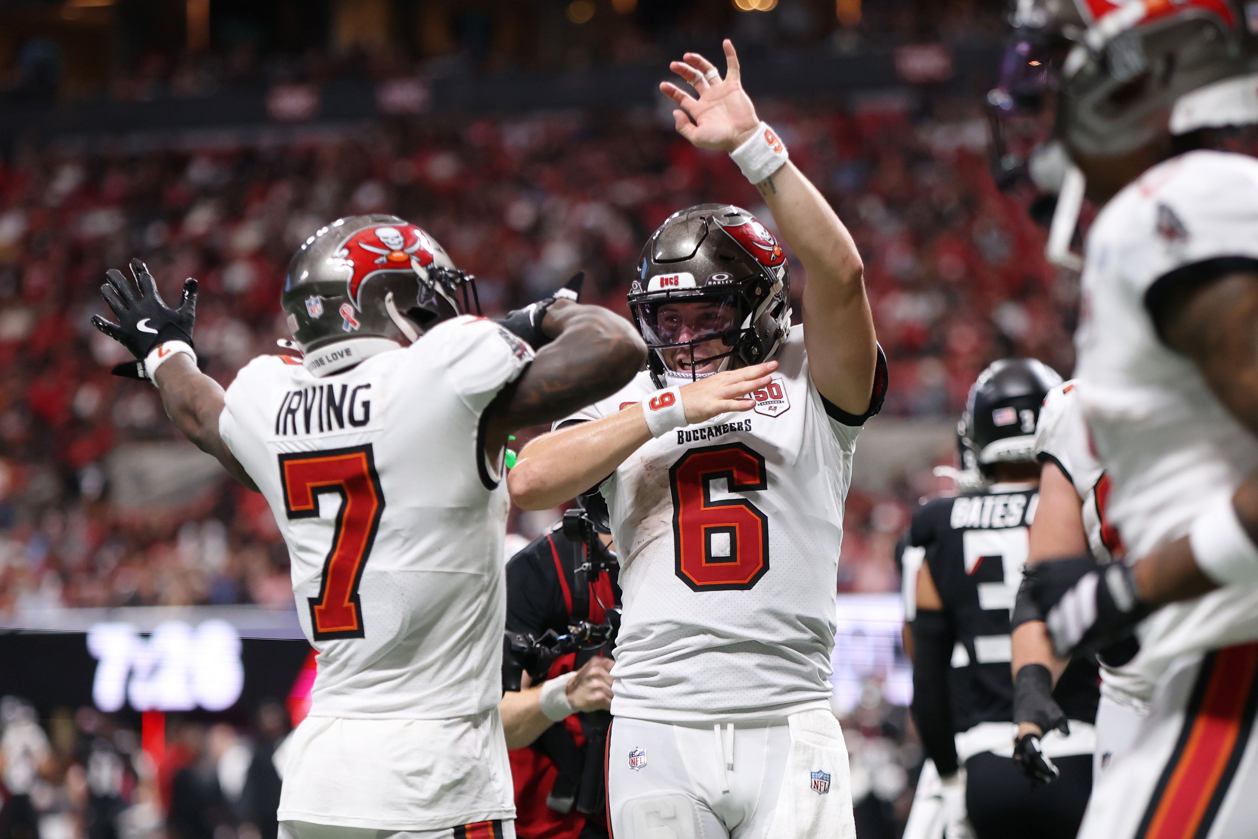 Sep 7, 2025; Atlanta, Georgia, USA; Tampa Bay Buccaneers running back Bucky Irving (7) celebrates with quarterback Baker Mayfield (6) after scoring a touchdown against the Atlanta Falcons during the third quarter at Mercedes-Benz Stadium.