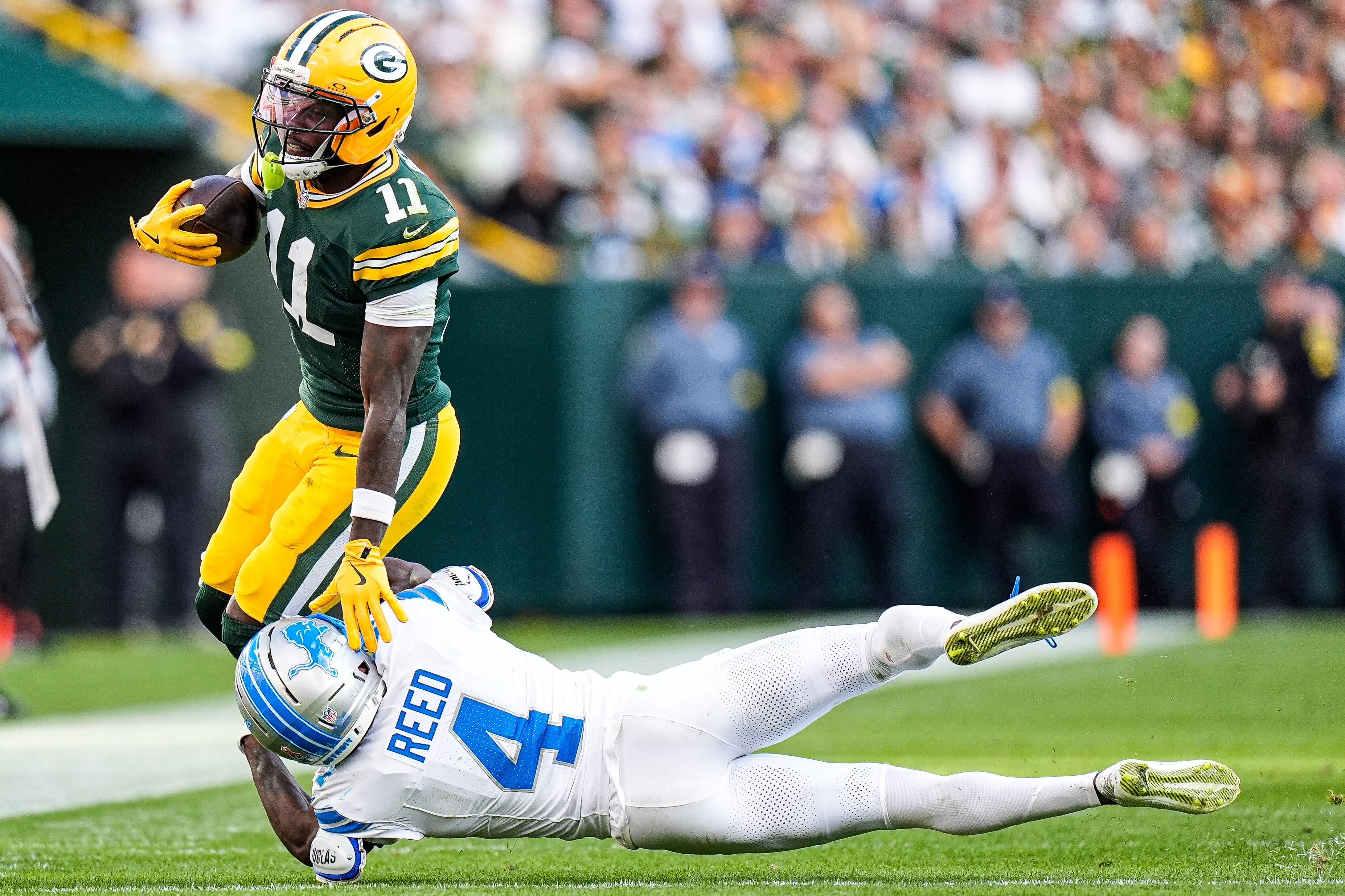 Detroit Lions cornerback D.J. Reed (4) tackles Green Bay Packers wide receiver Jayden Reed (11) during the second half at Lambeau Field in Green Bay, Wis., on Sunday, September 7, 2025.