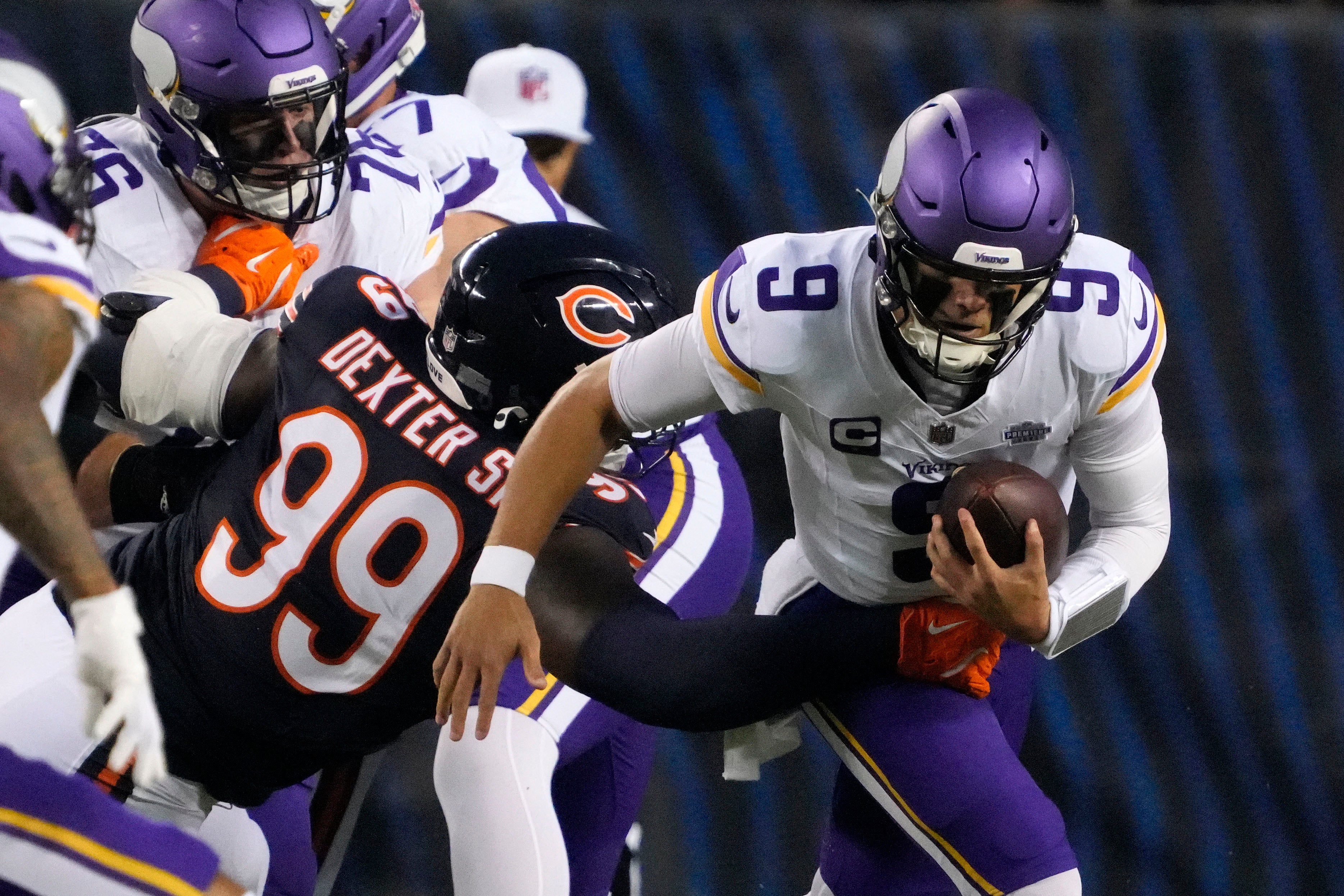 Sep 8, 2025; Chicago, Illinois, USA; Chicago Bears defensive tackle Gervon Dexter Sr. (99) tackles Minnesota Vikings quarterback J.J. McCarthy (9) during the first half at Soldier Field.