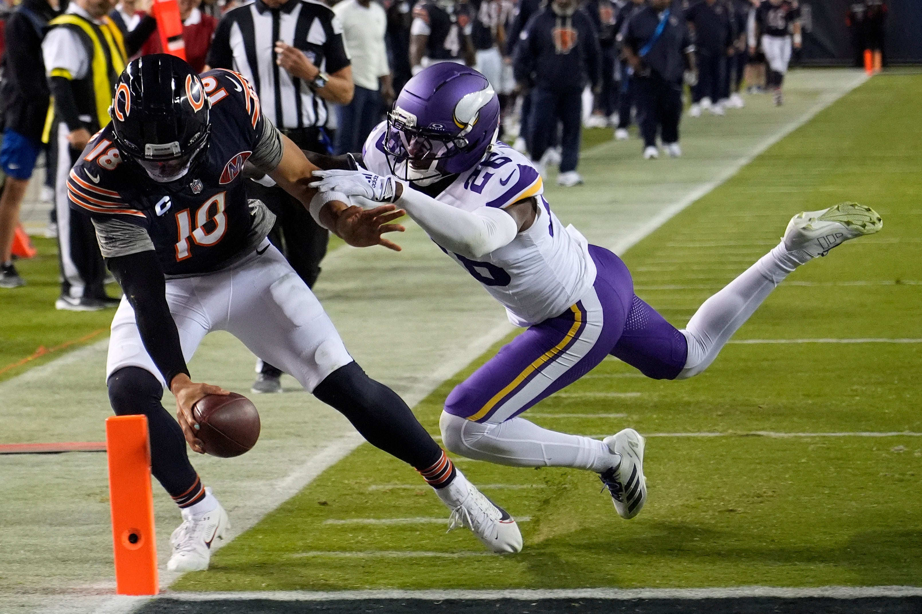 Sep 8, 2025; Chicago, Illinois, USA; Chicago Bears quarterback Caleb Williams (18) rushes the ball past Minnesota Vikings safety Theo Jackson (26) during the second half at Soldier Field.