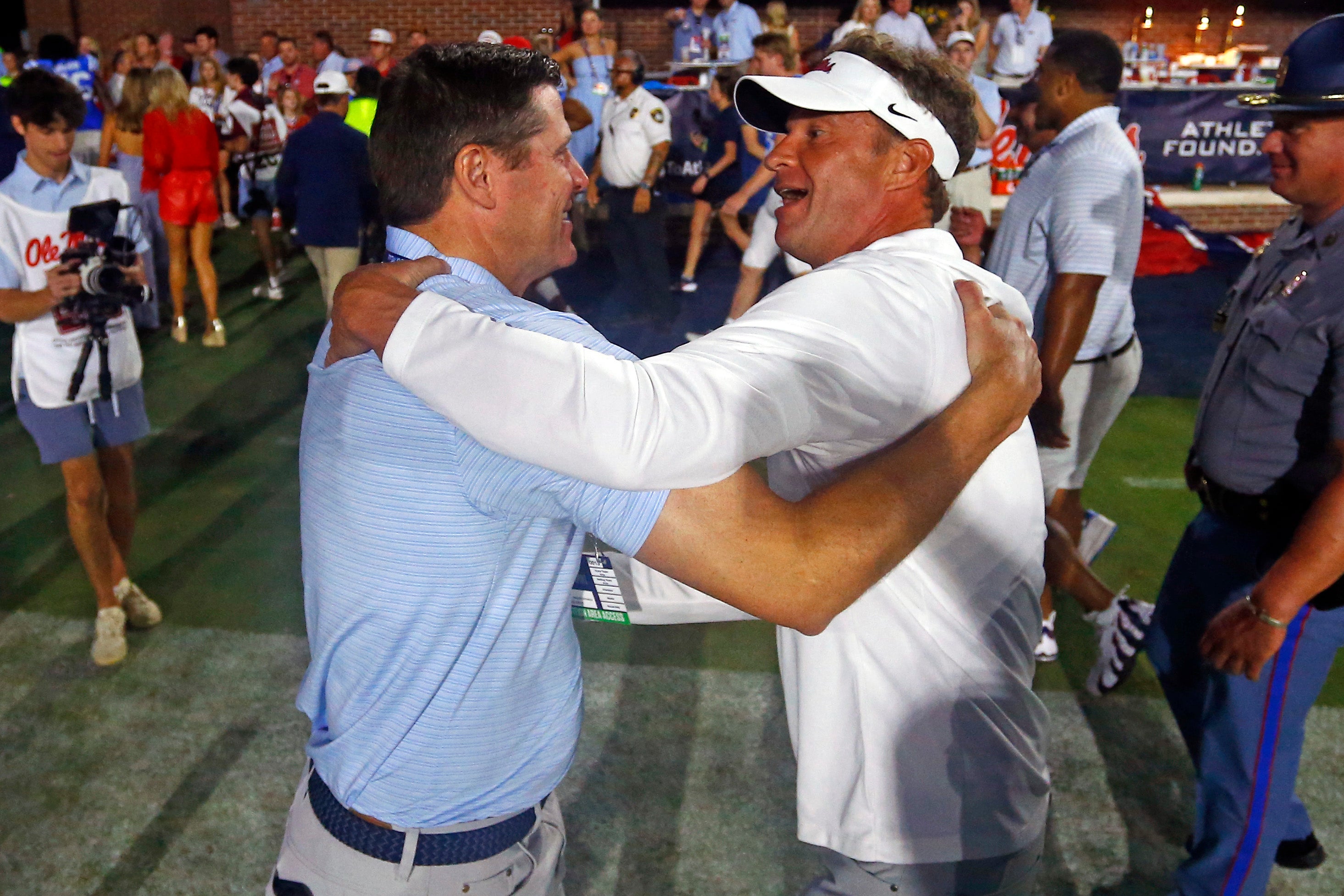 Sep 13, 2025; Oxford, Mississippi, USA; Mississippi Rebels head coach Lane Kiffin (right) reacts with Vice Chancellor for Intercollegiate Athletics Keith Carter (left) after defeating the Arkansas Razorback at Vaught-Hemingway Stadium.