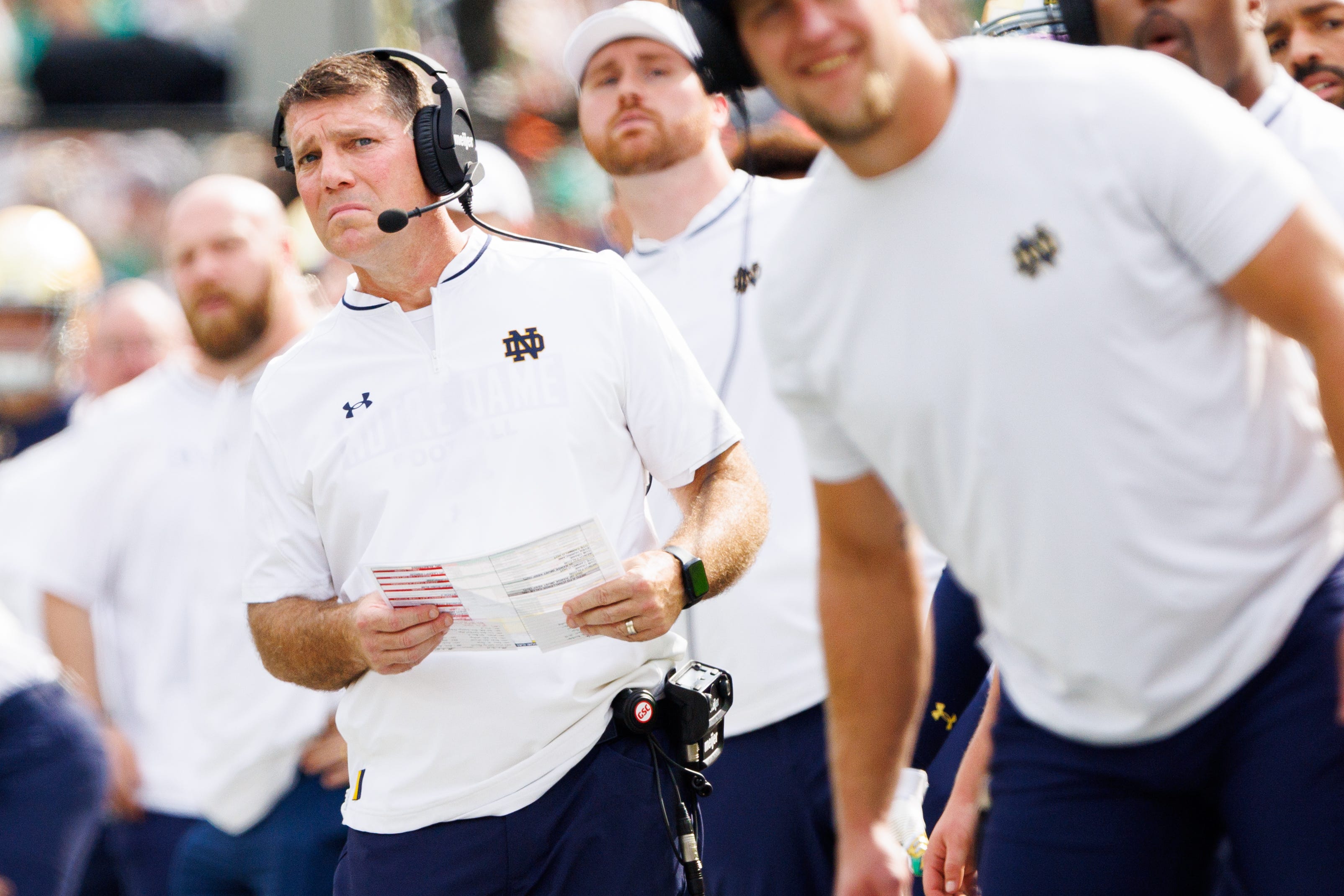 Notre Dame defensive coordinator Chris Ash, left, looks on during the first half of a NCAA football game against Purdue at Notre Dame Stadium on Saturday, Sept. 20, 2025, in South Bend.