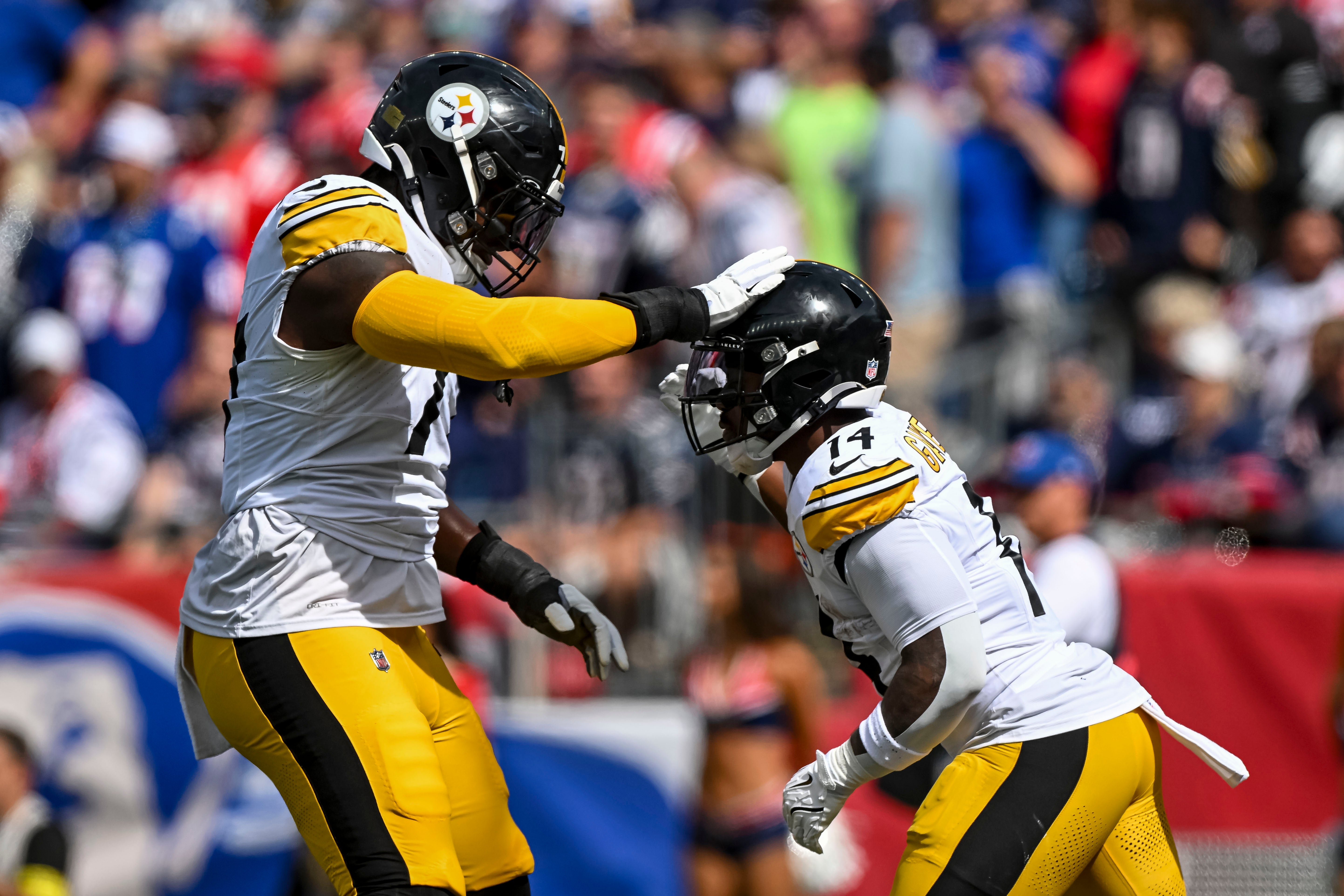 Sep 21, 2025; Foxborough, Massachusetts, USA; Pittsburgh Steelers running back Kenneth Gainwell (14) and Pittsburgh Steelers offensive tackle Broderick Jones (77) react after a touchdown during the first quarter at Gillette Stadium.