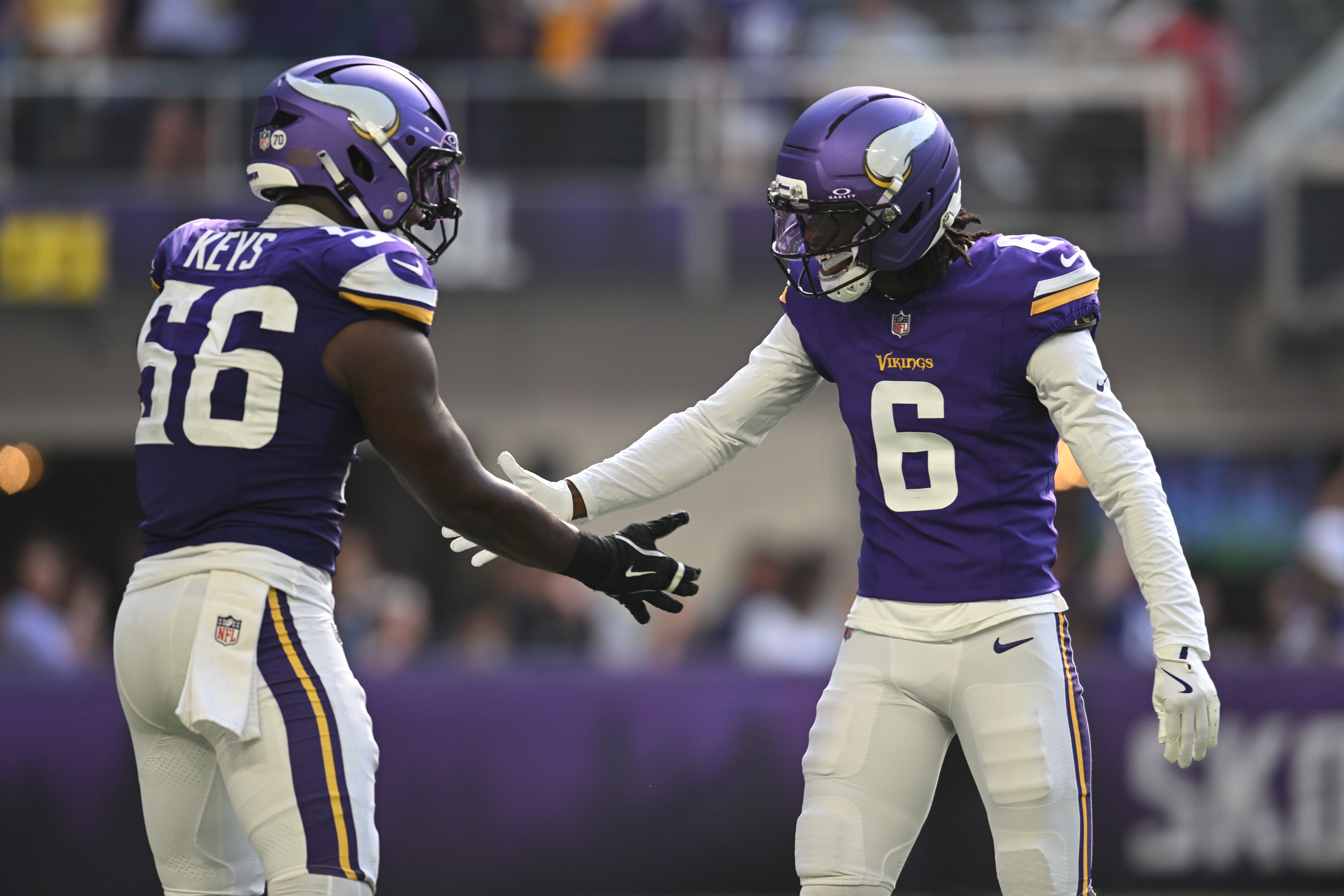 Sep 21, 2025; Minneapolis, Minnesota, USA; Minnesota Vikings linebacker Austin Keys (56) reacts with cornerback Dwight McGlothern (6) after a sack against the Cincinnati Bengals during the second half at U.S. Bank Stadium.