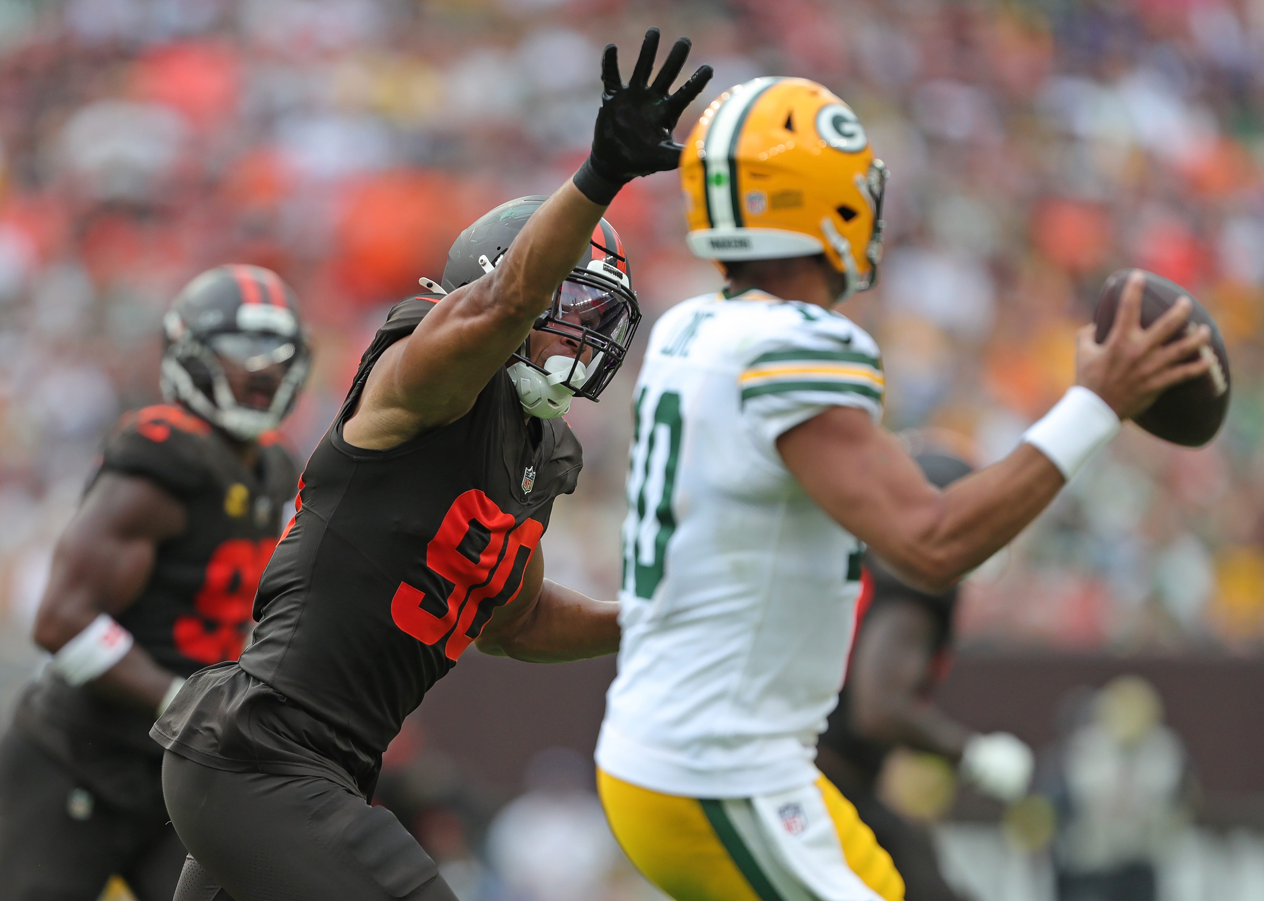 Cleveland Browns defensive end Joe Tryon-Shoyinka (90) pressures Green Bay Packers quarterback Jordan Love (10) during the second half of an NFL football game at Huntington Bank Field, Sept. 21, 2025, in Cleveland, Ohio.