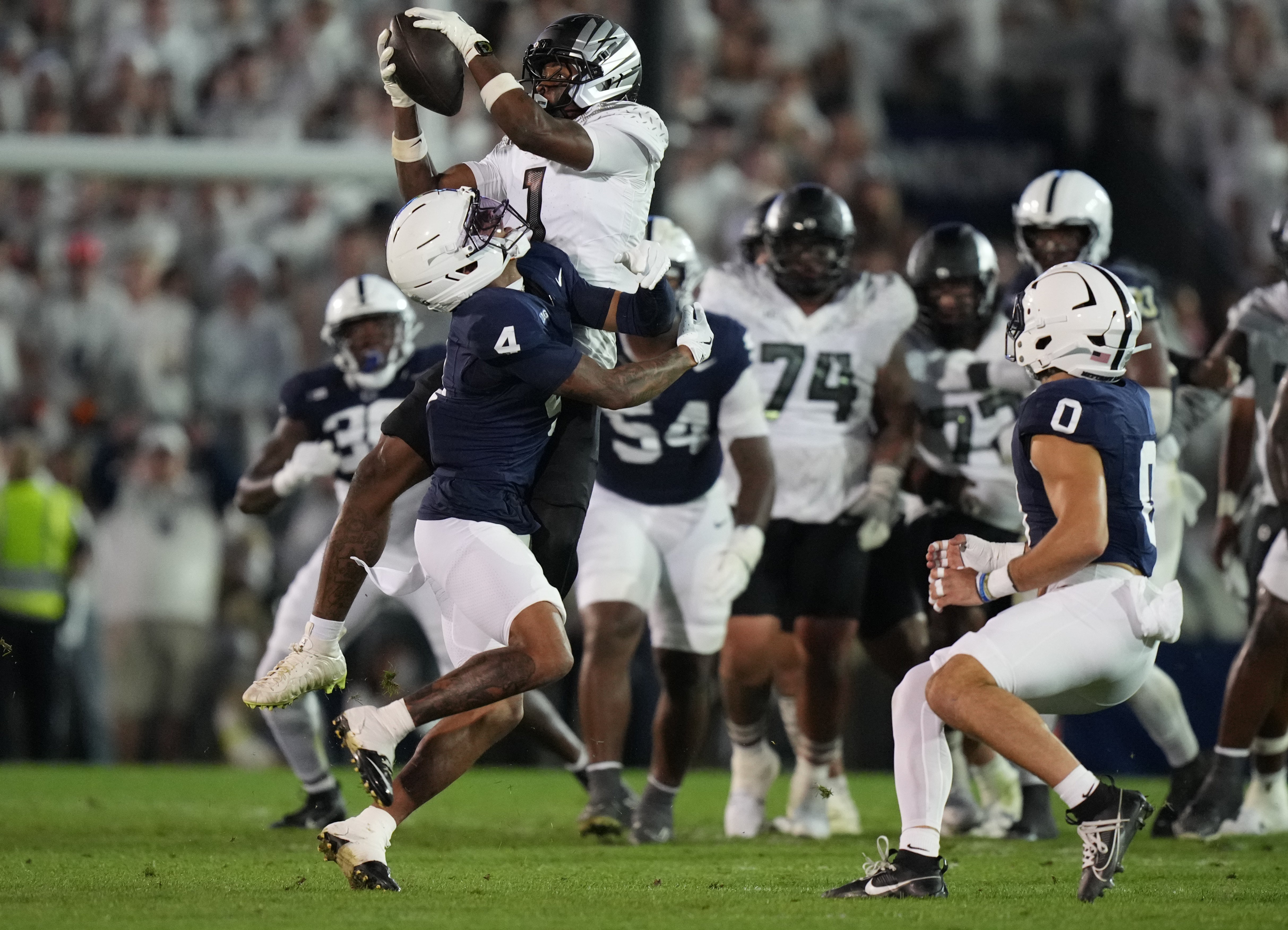 Sep 27, 2025; University Park, Pennsylvania, USA; Penn State Nittany Lions wide receiver Kyron Hudson (1) is tackled by Penn State Nittany Lions cornerback A.J. Harris (4) during the first quarter at Beaver Stadium. Mandatory Credit: James Lang-Imagn Images