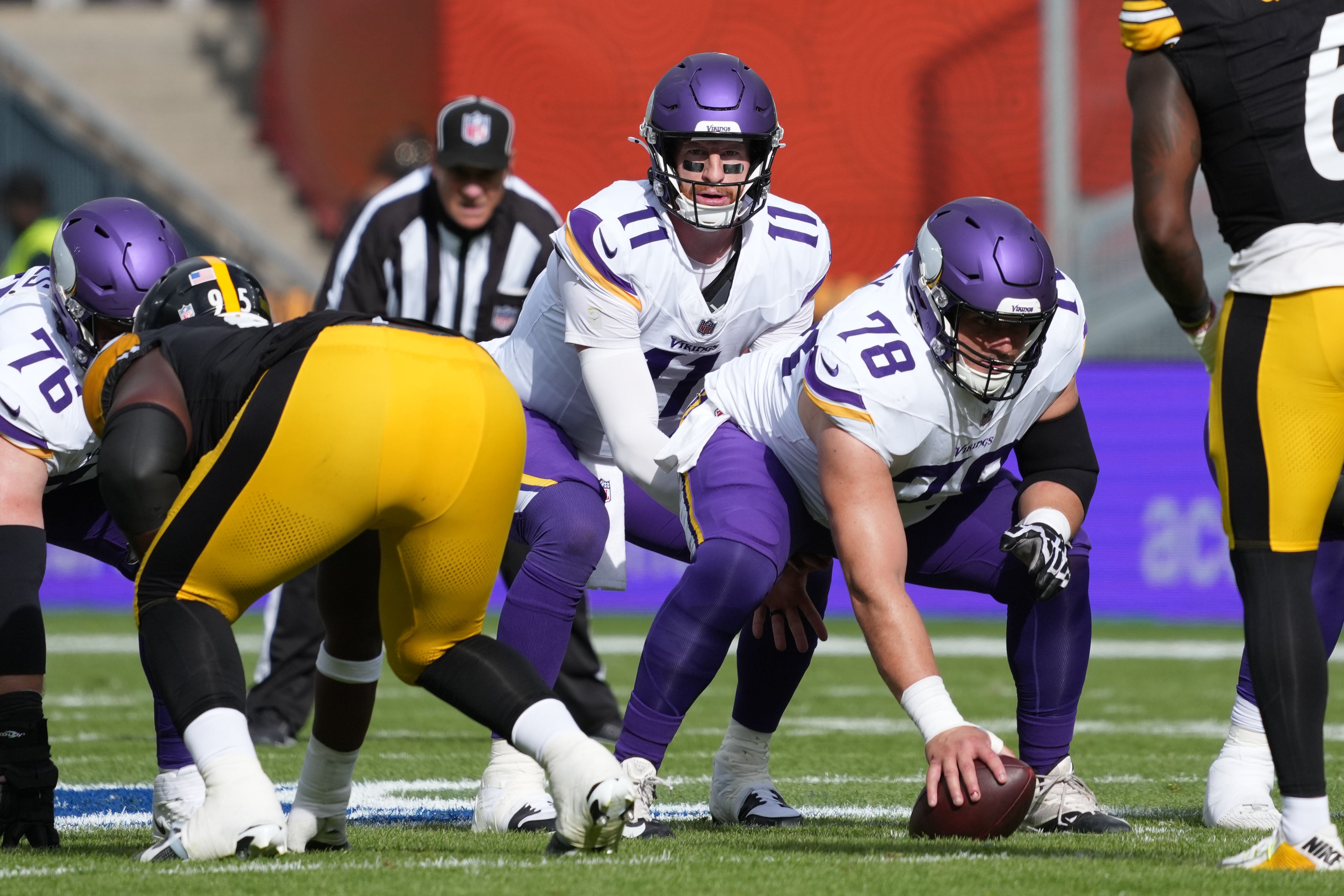 Sep 28, 2025; Dublin, Ireland; Minnesota Vikings quarterback Carson Wentz (11) takes the snap from center Ryan Kelly (78) in the first half against the Pittsburgh Steelers during an NFL International Series game at Croke Park.