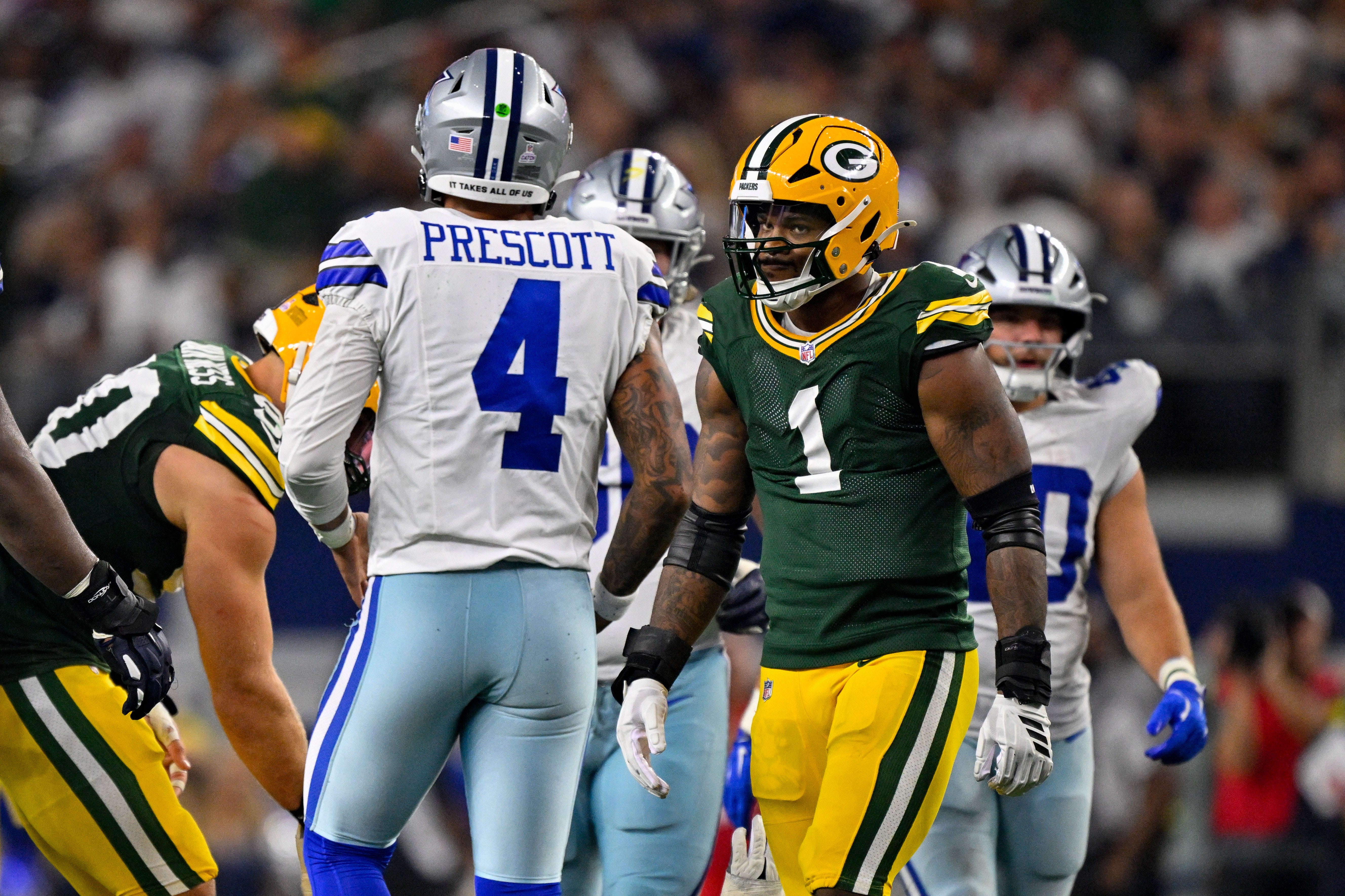 Sep 28, 2025; Arlington, Texas, USA; Green Bay Packers defensive end Micah Parsons (1) stares at Dallas Cowboys quarterback Dak Prescott (4) during the game between the Dallas Cowboys and the Green Bay Packers at AT&T Stadium.