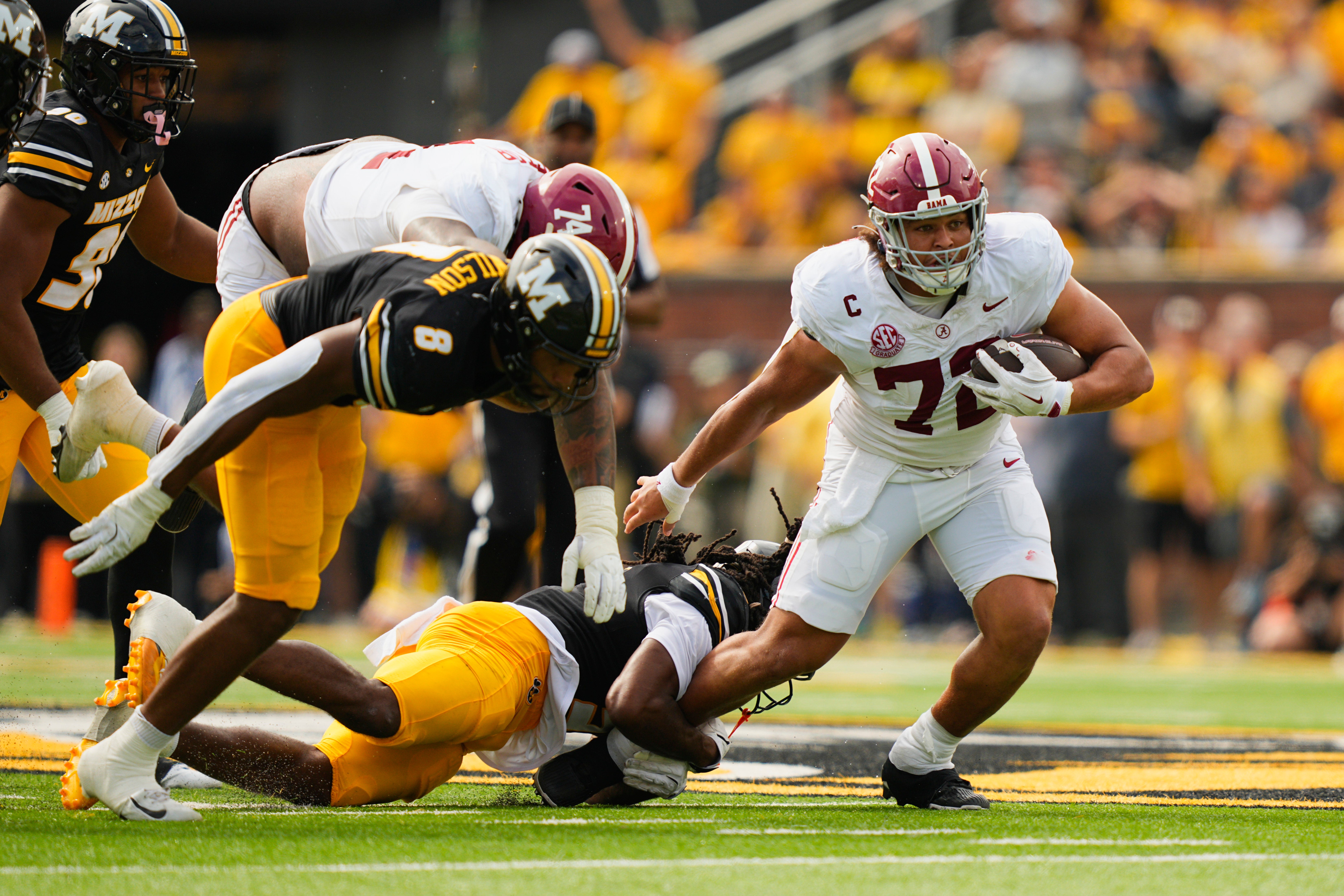 Oct 11, 2025; Columbia, Missouri, USA; Alabama Crimson Tide offensive lineman Parker Brailsford (72) catches a deflected pass and is tackled by Missouri Tigers linebacker Khalil Jacobs (5) during the second half of the game at Faurot Field at Memorial Stadium.