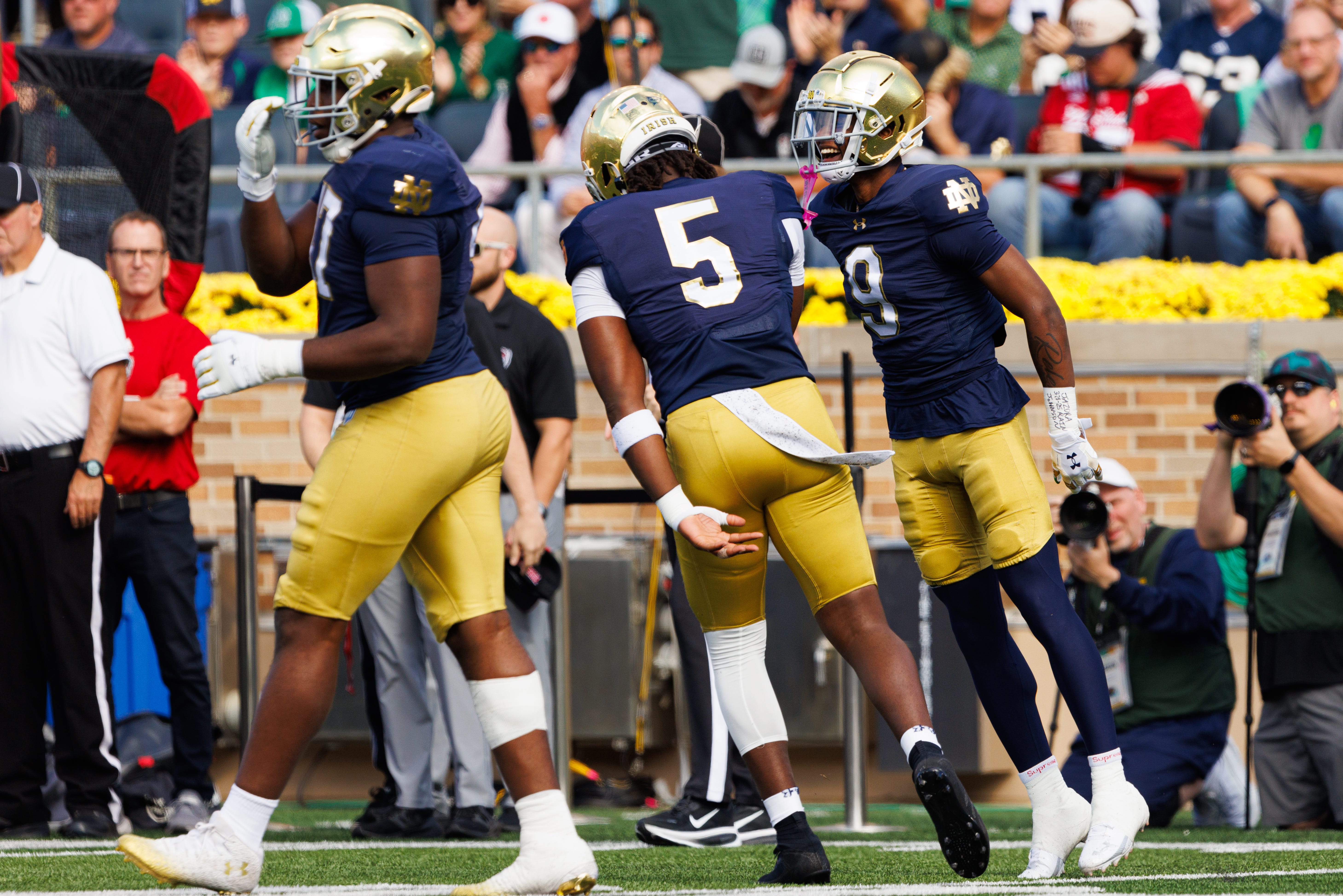 Notre Dame safety Tae Johnson (9) and defensive lineman Boubacar Traore (5) celebrate a sack by Traore in the first half of a NCAA football game against NC State at Notre Dame Stadium on Saturday, Oct. 11, 2025, in South Bend.