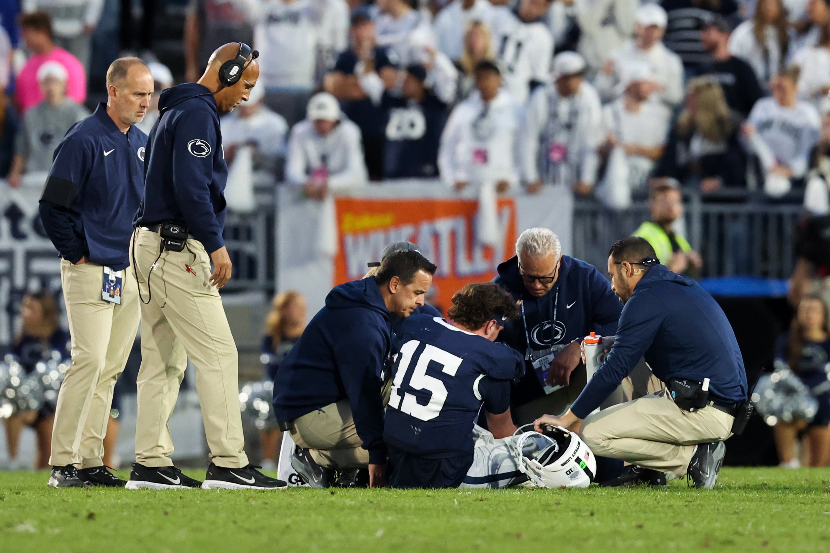 Oct 11, 2025; University Park, Pennsylvania, USA; Penn State Nittany Lions head coach James Franklin looks over quarterback Drew Allar (15) as he sit injured on the ground during the fourth quarter against the Northwestern Wildcats at Beaver Stadium. Mandatory Credit: Matthew O'Haren-Imagn Images
