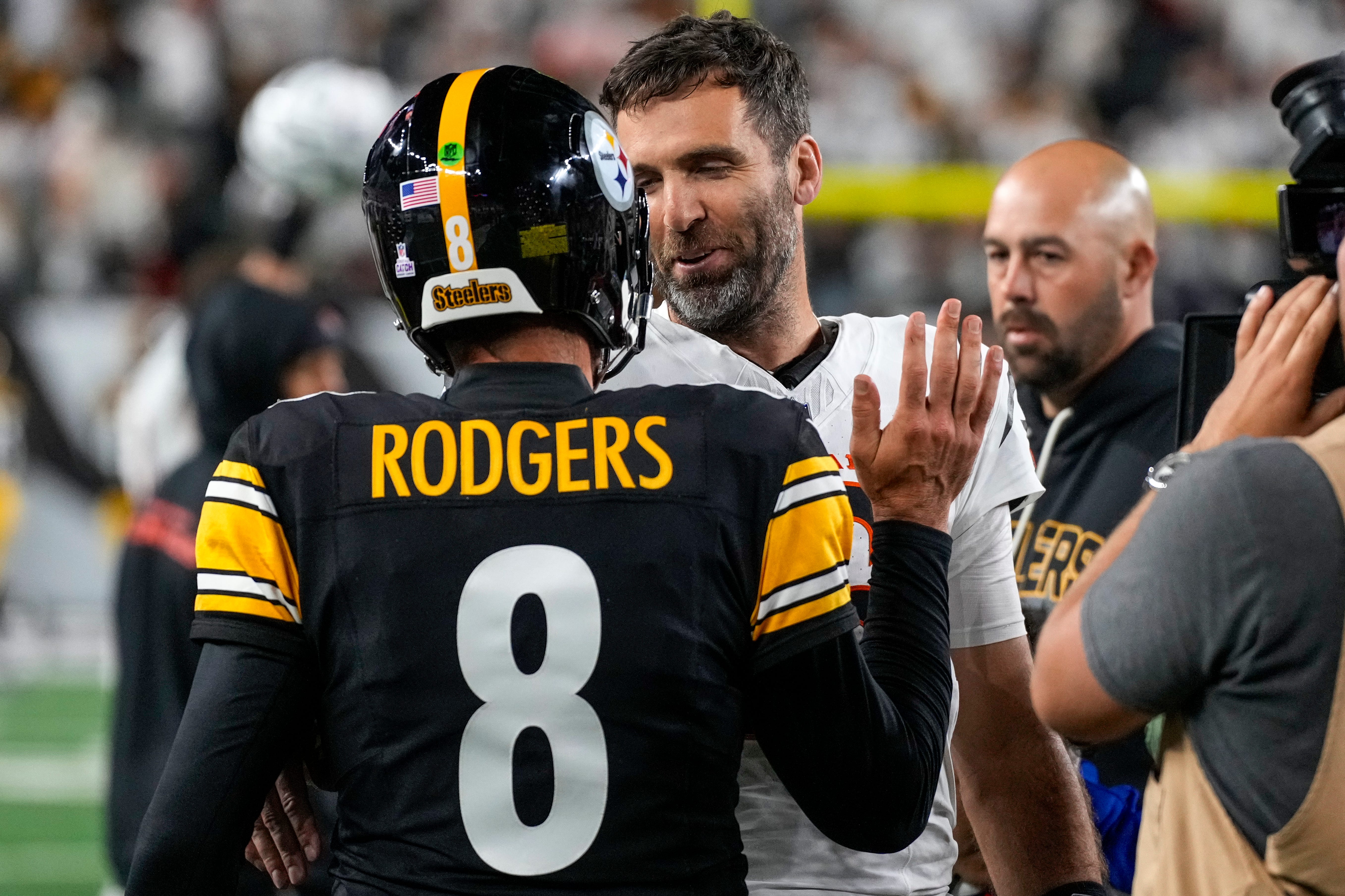 Pittsburgh Steelers quarterback Aaron Rodgers (8) and Cincinnati Bengals quarterback Joe Flacco (16) shake hands after the fourth quarter of the NFL Week 7 game between the Cincinnati Bengals and the Pittsburgh Steelers at Paycor Stadium in downtown Cincinnati on Thursday, Oct. 16, 2025. The Bengals won, 33-31.