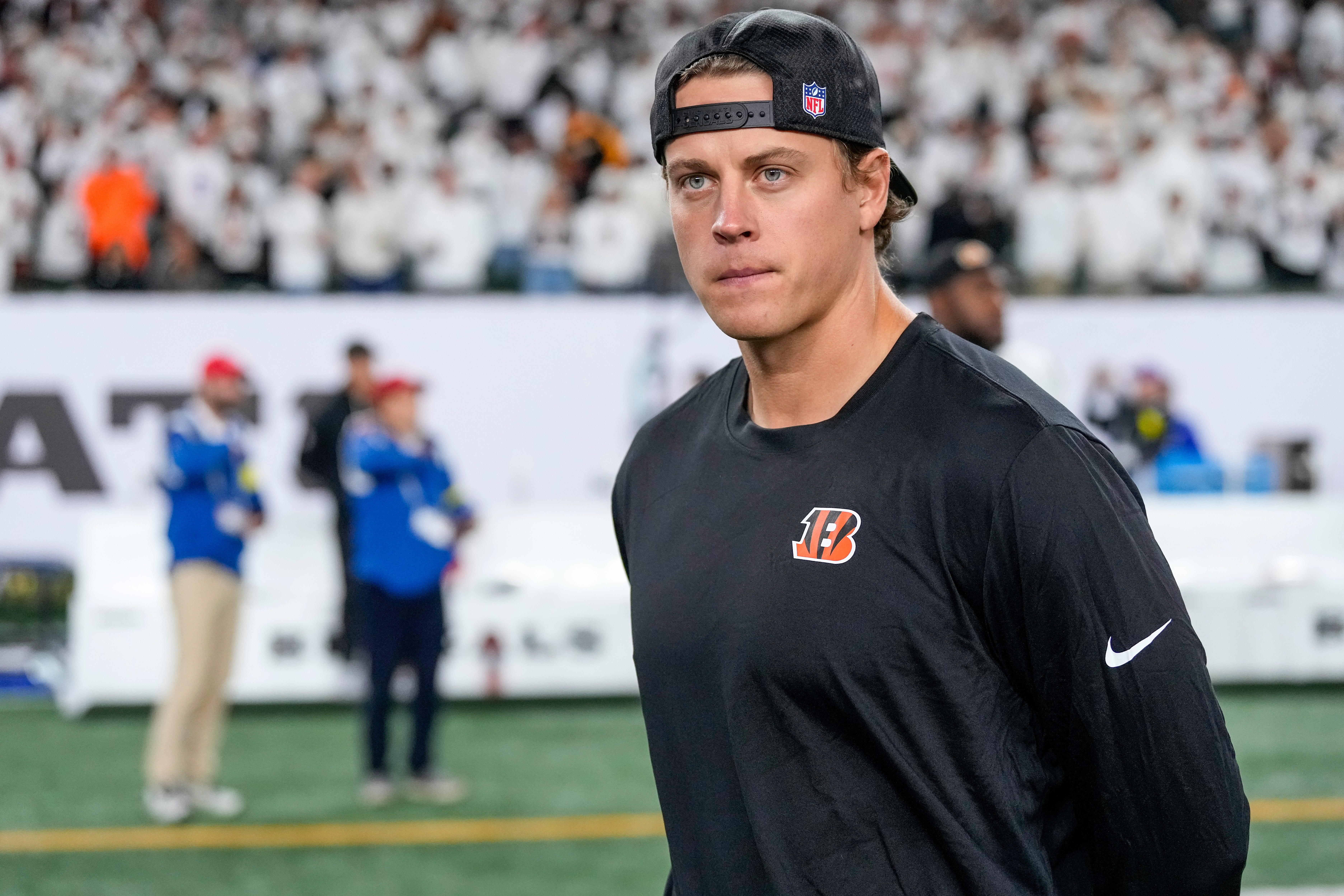 Injured Cincinnati Bengals quarterback Joe Burrow (9) walks on the field after the fourth quarter of the NFL Week 7 game between the Cincinnati Bengals and the Pittsburgh Steelers at Paycor Stadium in downtown Cincinnati on Thursday, Oct. 16, 2025. The Bengals won, 33-31.