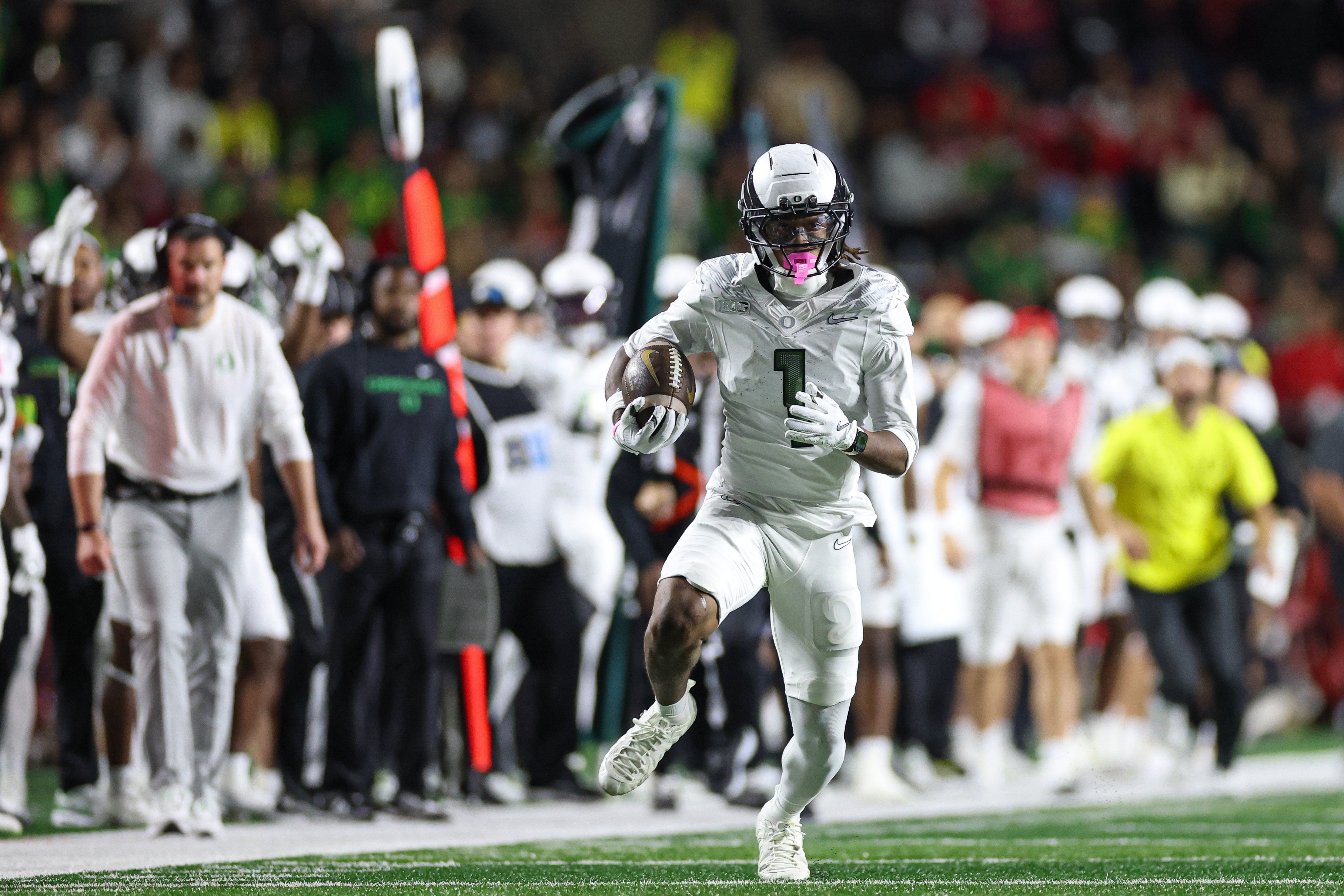 Oct 18, 2025; Piscataway, New Jersey, USA; Oregon Ducks wide receiver Dakorien Moore (1) gains yards after catch during the first half against the Rutgers Scarlet Knights at SHI Stadium. Mandatory Credit: Vincent Carchietta-Imagn Images