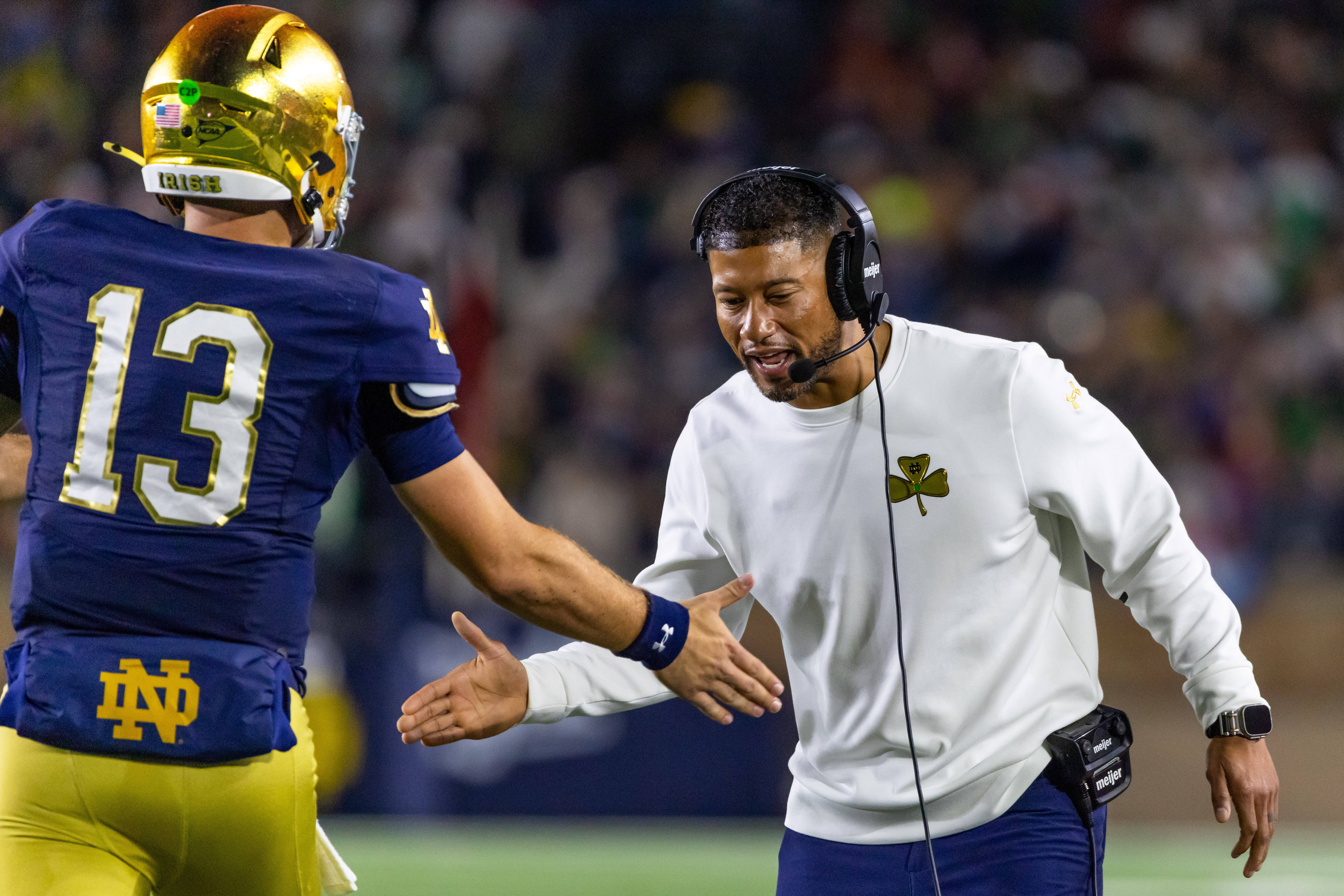 Oct 18, 2025; South Bend, Indiana, USA; Notre Dame Fighting Irish head coach Marcus Freeman celebrates with quarterback CJ Carr (13) during the first half against the Southern California Trojans at Notre Dame Stadium. Mandatory Credit: Michael Caterina-Imagn Images