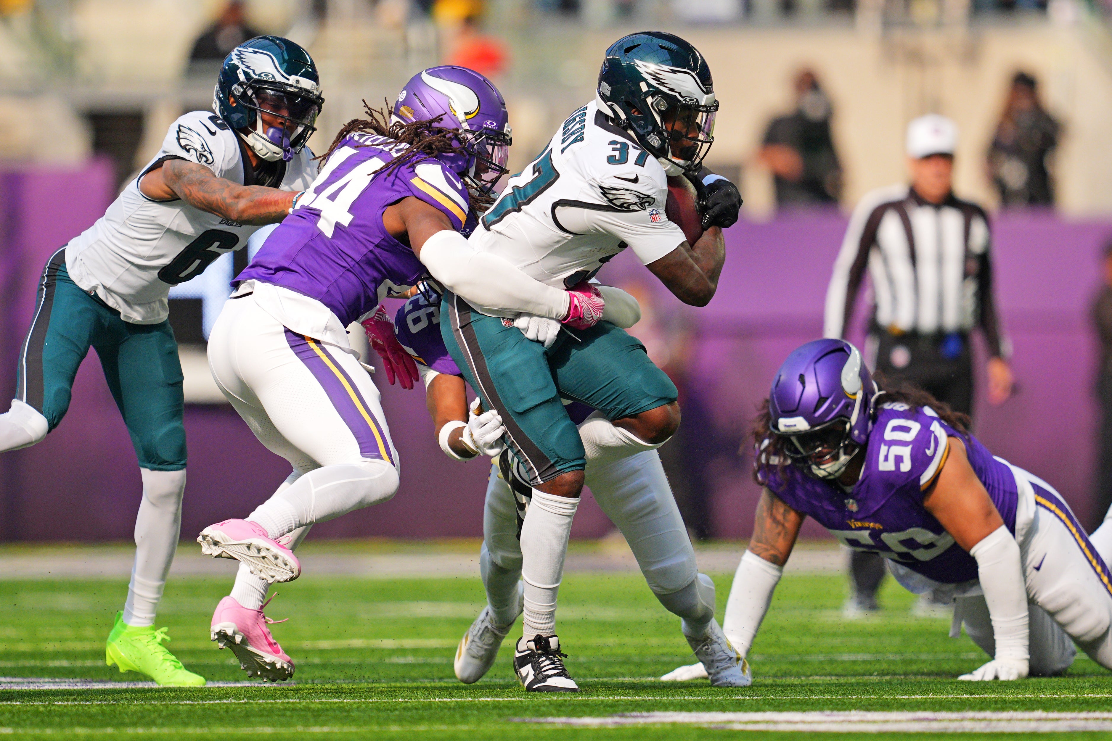 Oct 19, 2025; Minneapolis, Minnesota, USA; Minnesota Vikings safety Josh Metellus (44) goes for a tackle Philadelphia Eagles running back Tank Bigsby (37) during the first half at U.S. Bank Stadium.