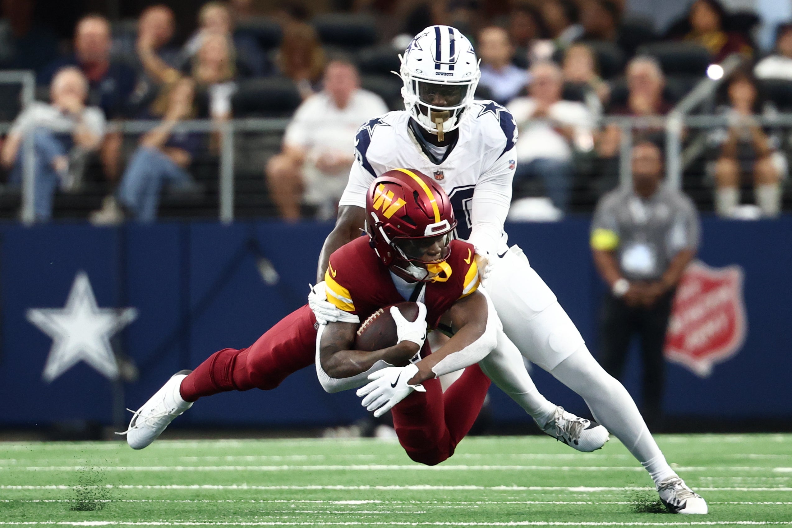 Oct 19, 2025; Arlington, Texas, USA; Dallas Cowboys cornerback Kaiir Elam (20) tackles Washington Commanders running back Jacory Croskey-Merritt (22) during the first quarter of the game at AT&T Stadium.
